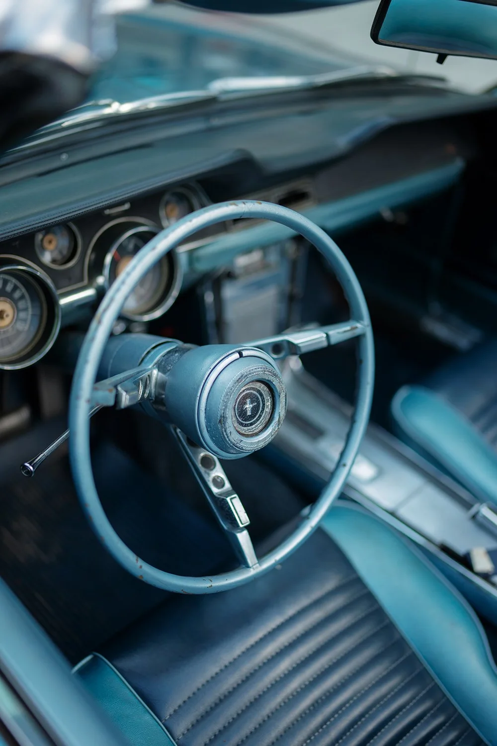 Steering wheel and dashboard inside the blue Mustang convertible