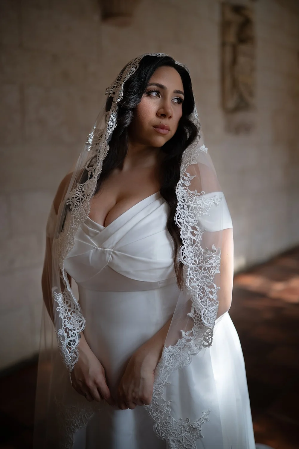 Portrait of Maria in a white gown and lace mantilla veil, lit by soft window light