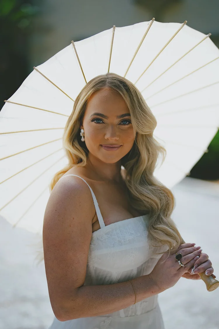 Film portrait of Jane holding a white paper parasol in the sun