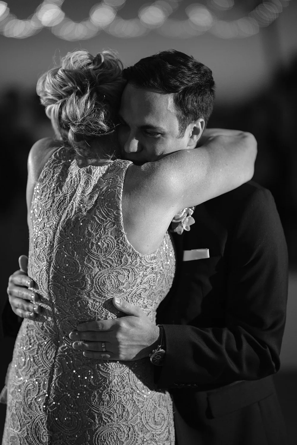 Black and white photo of Berkeley hugging a woman in a beaded dress on the dance floor