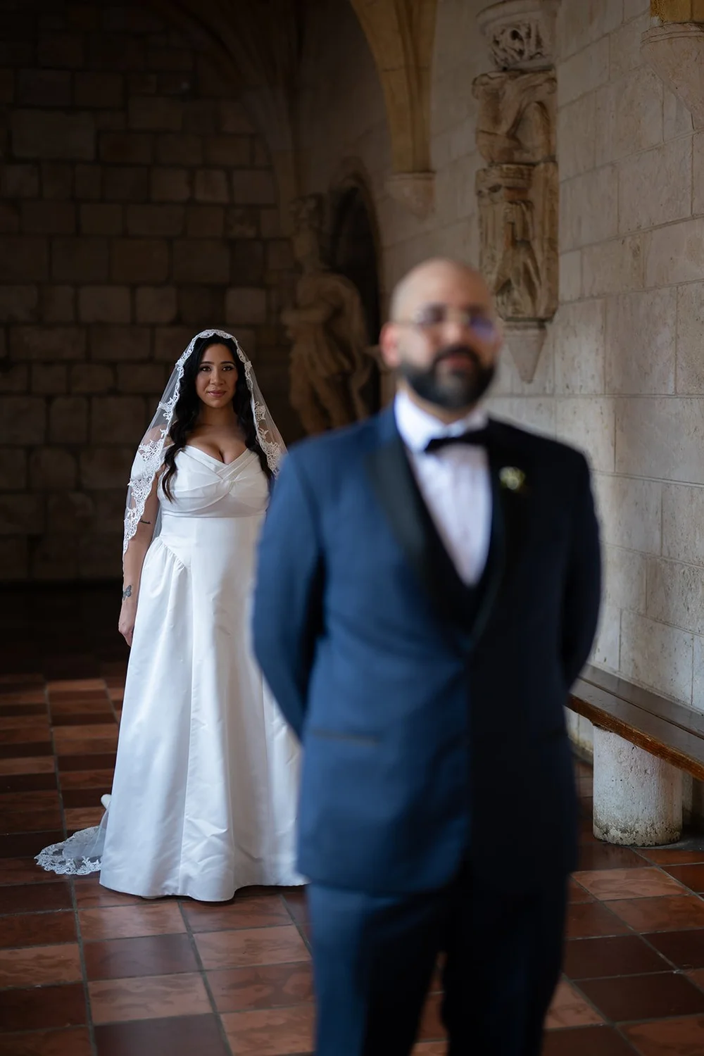 Maria and Christian standing side by side in the monastery cloister before the ceremony