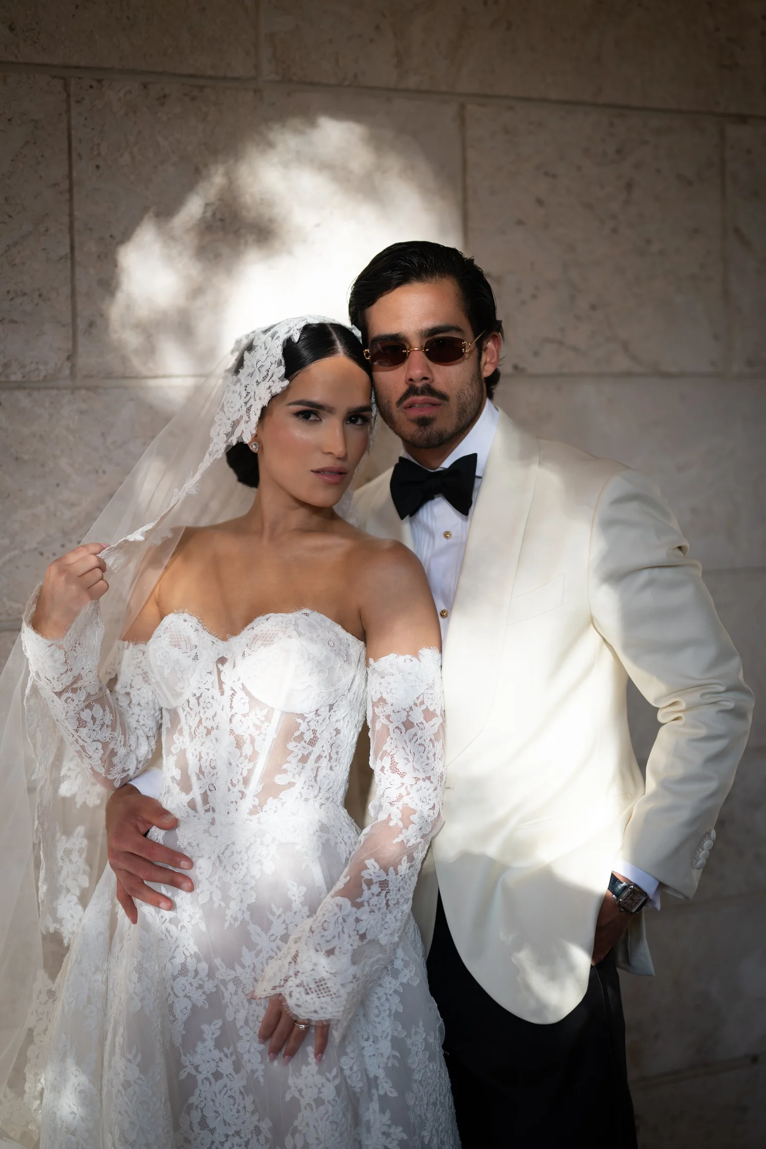 Bride and groom portrait in a cream tuxedo and lace gown