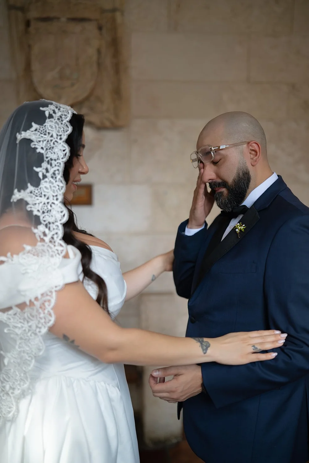 Christian touching his eye in an emotional moment while Maria rests her hand on his chest