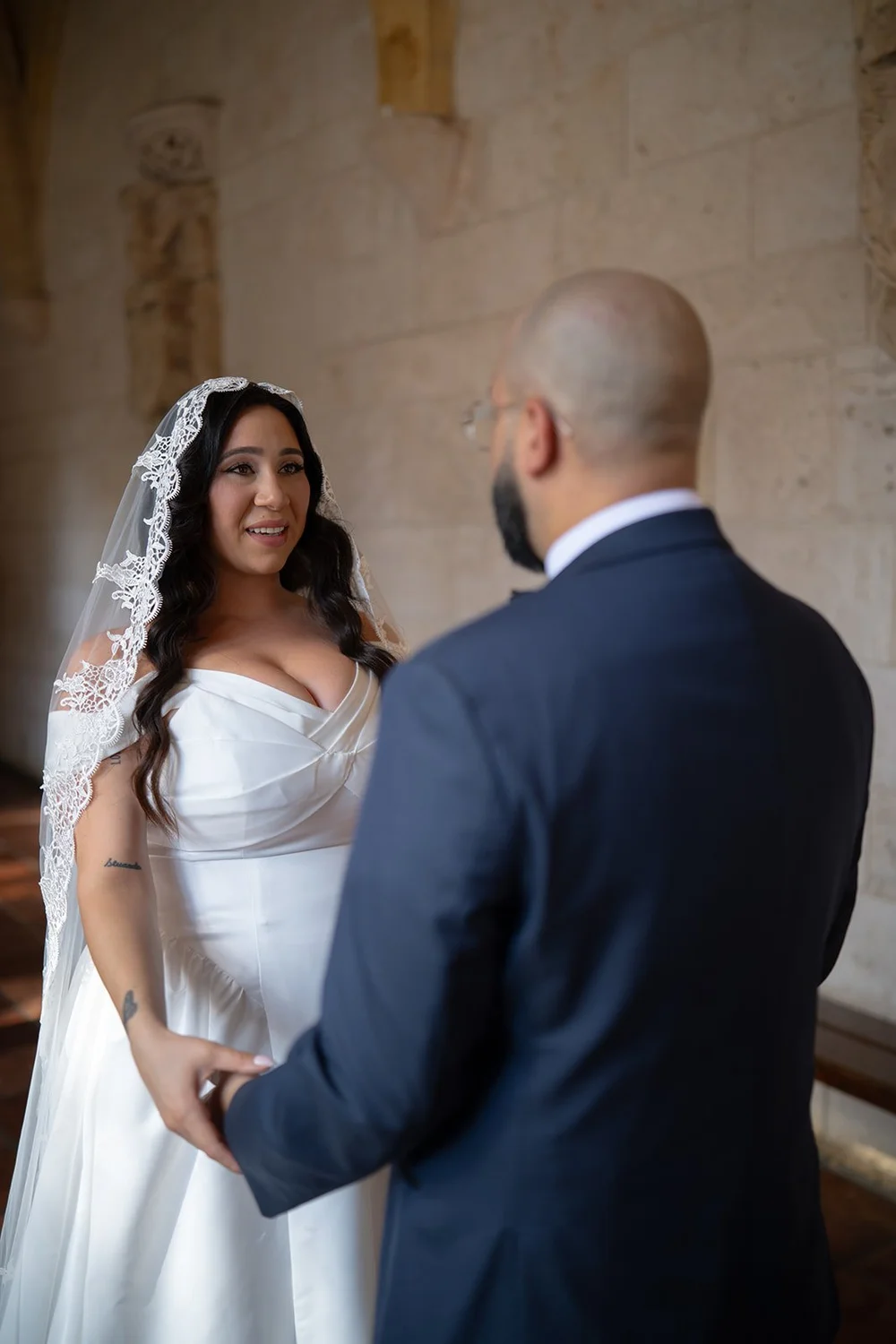 Maria and Christian sharing an emotional moment in the cloister, his hands holding hers