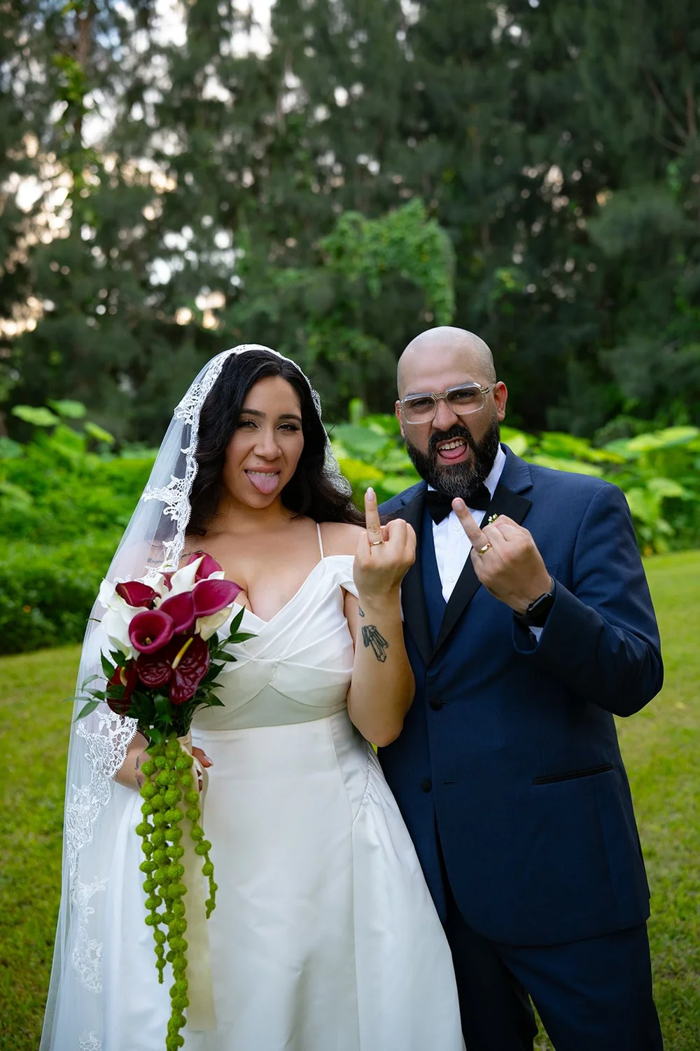 Maria and Christian holding up their hands in a playful pose in the gardens