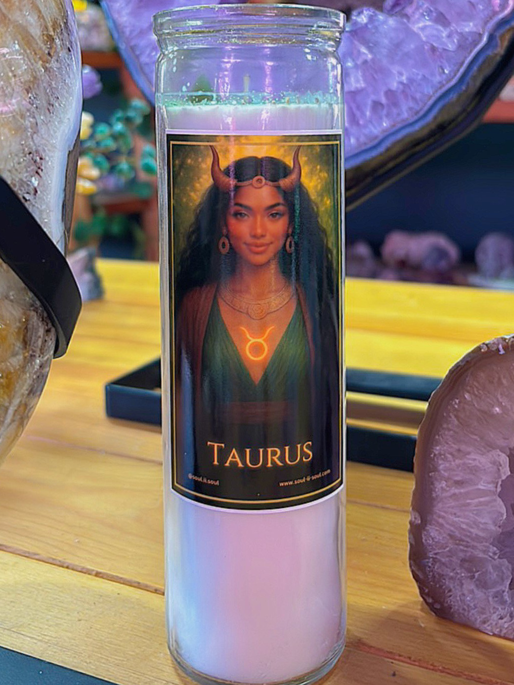 Taurus zodiac ritual candle by Soul II Soul featuring a serene goddess with a glowing Taurus symbol, in a candle jar.