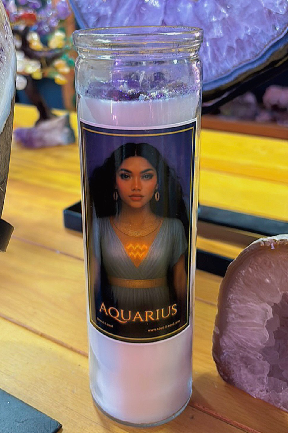 Aquarius zodiac ritual candle by Soul II Soul featuring a goddess with a glowing Aquarius symbol, in a candle jar.