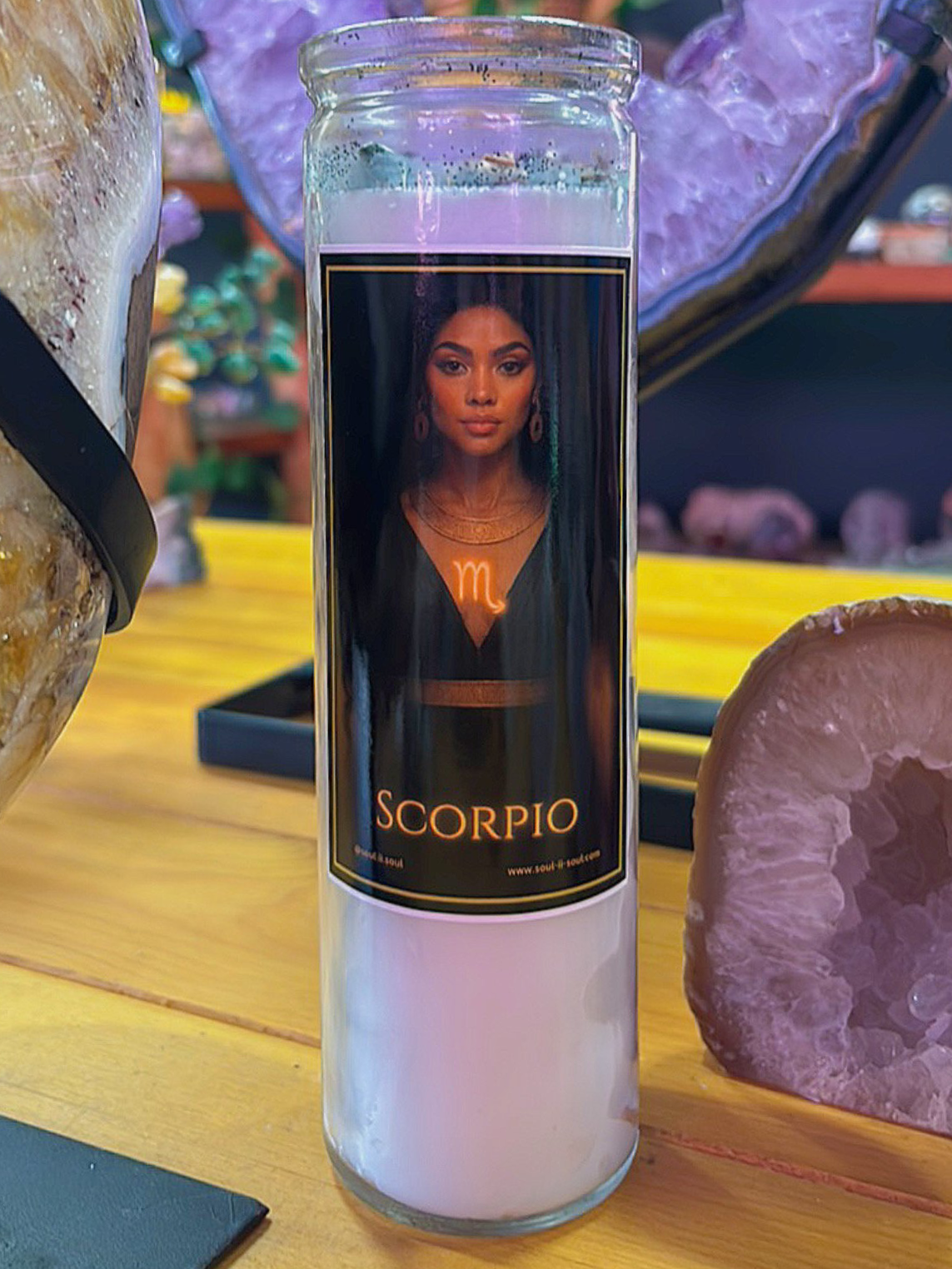 Scorpio zodiac ritual candle by Soul II Soul featuring a mysterious goddess with intense eyes and a glowing Scorpio symbol, in a candle jar