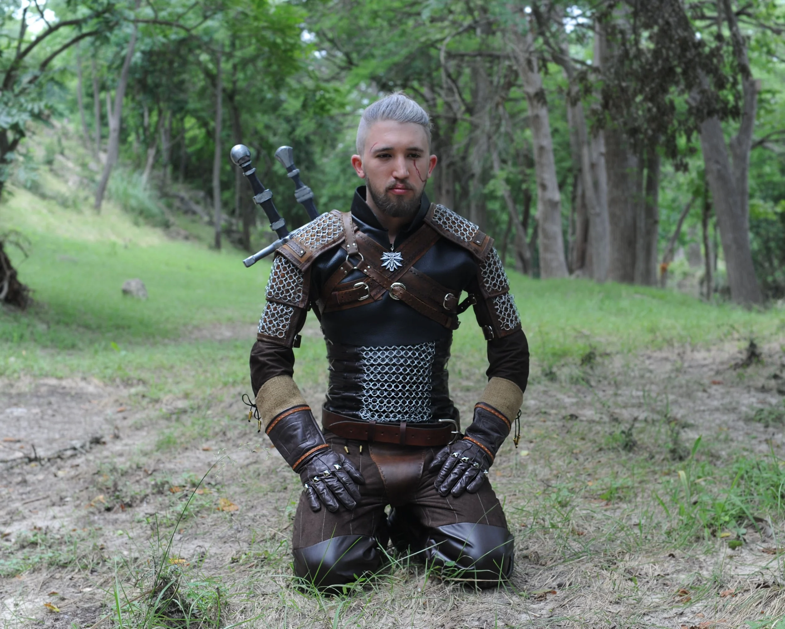 High detail Geralt of Rivia cosplay from The Witcher 3: Wild Hunt by Tiffany Gordon Cosplay. Featuring hand crafted leather armor, chainmail accents, and twin Witcher swords, this build is a screen accurate representation of the iconic monster hunter