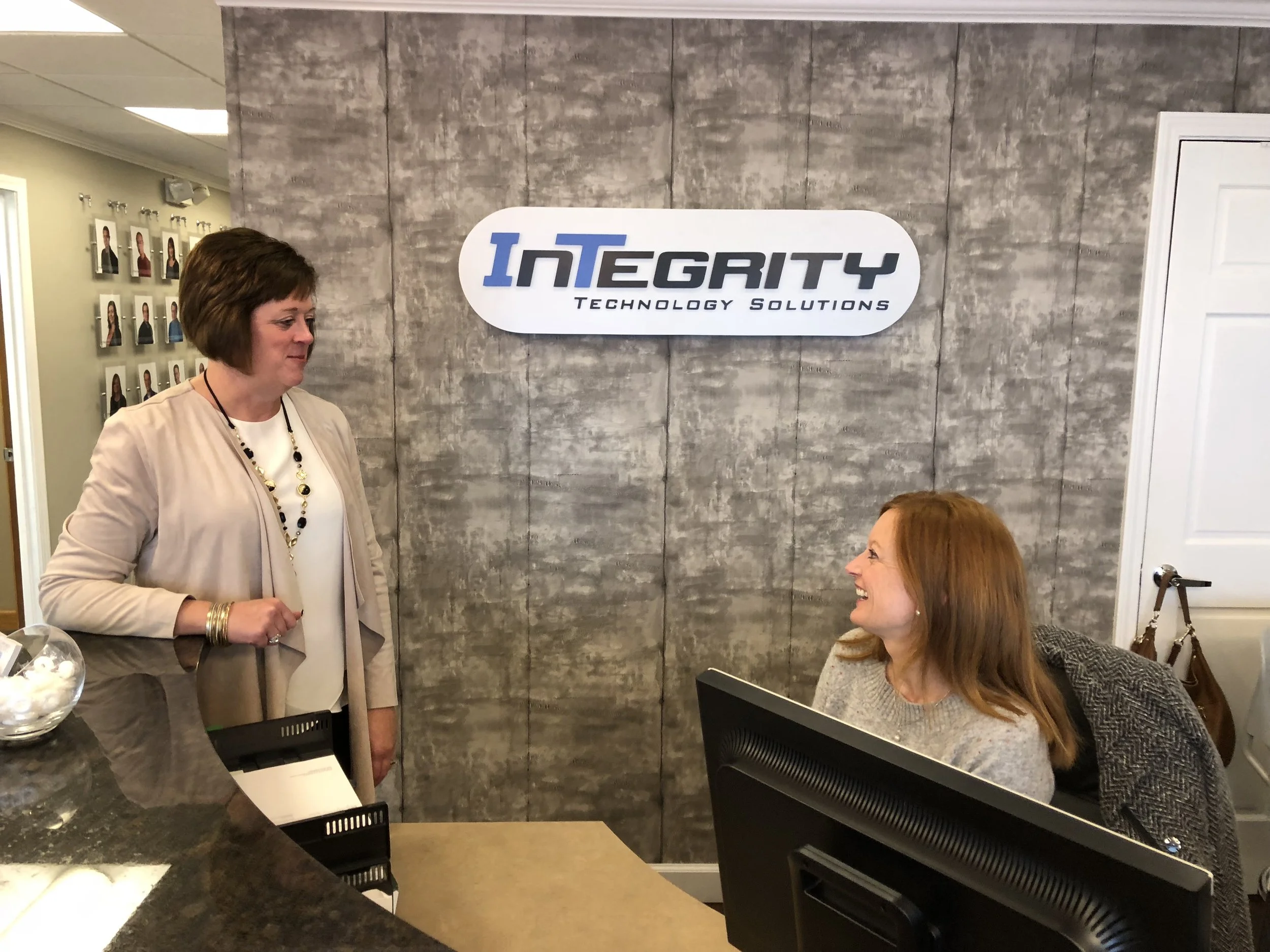 Mary Bennet Henrichs talks business with associate Cindy Giessinger at Integrity Technology Solutions. (Credit: Erik Prenzler)