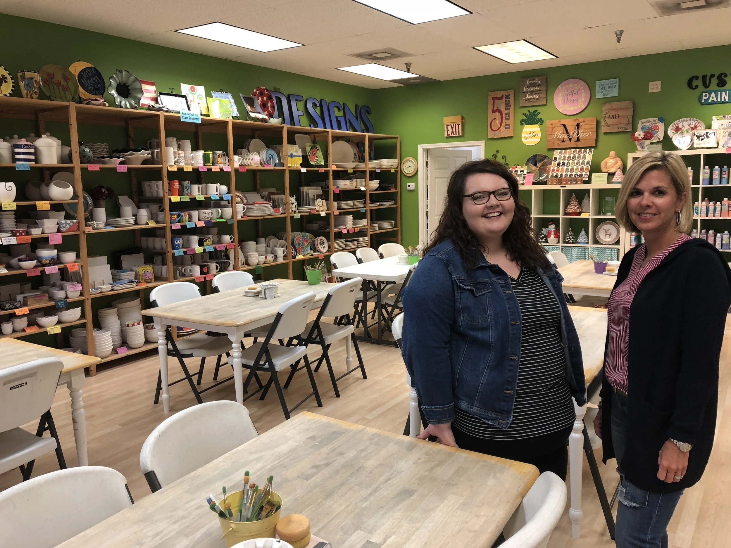 Artful Designs owner Wendy Ives (right) and manager Chelsea Achord (right) give AdaptBN a tour of the studio.