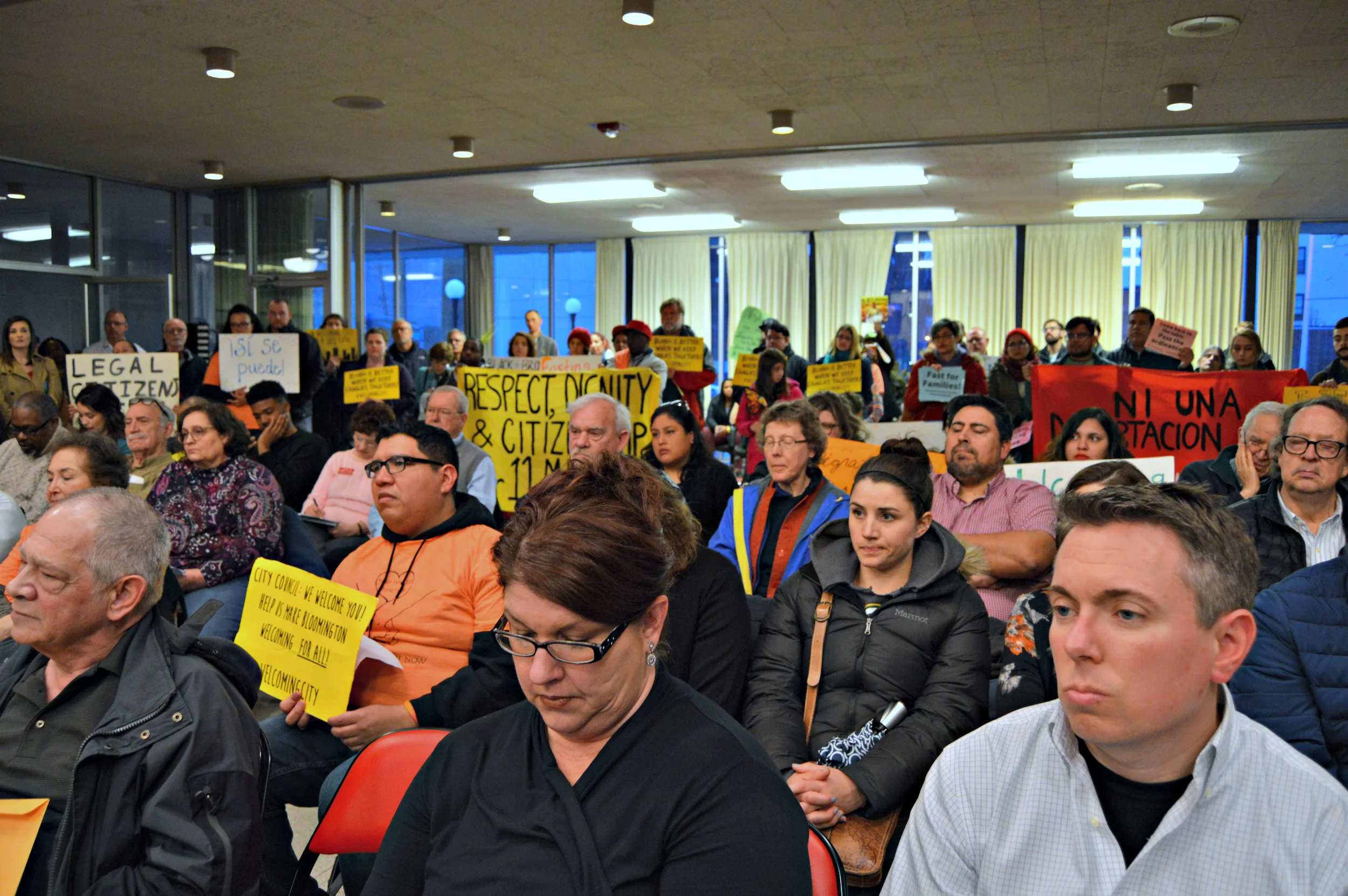 Members of the Keep Families Together coalition staged a walkout at a March 26th Council meeting in protest of council members' inaction on a welcoming city ordinance. (Image credit: Breanna Grow)