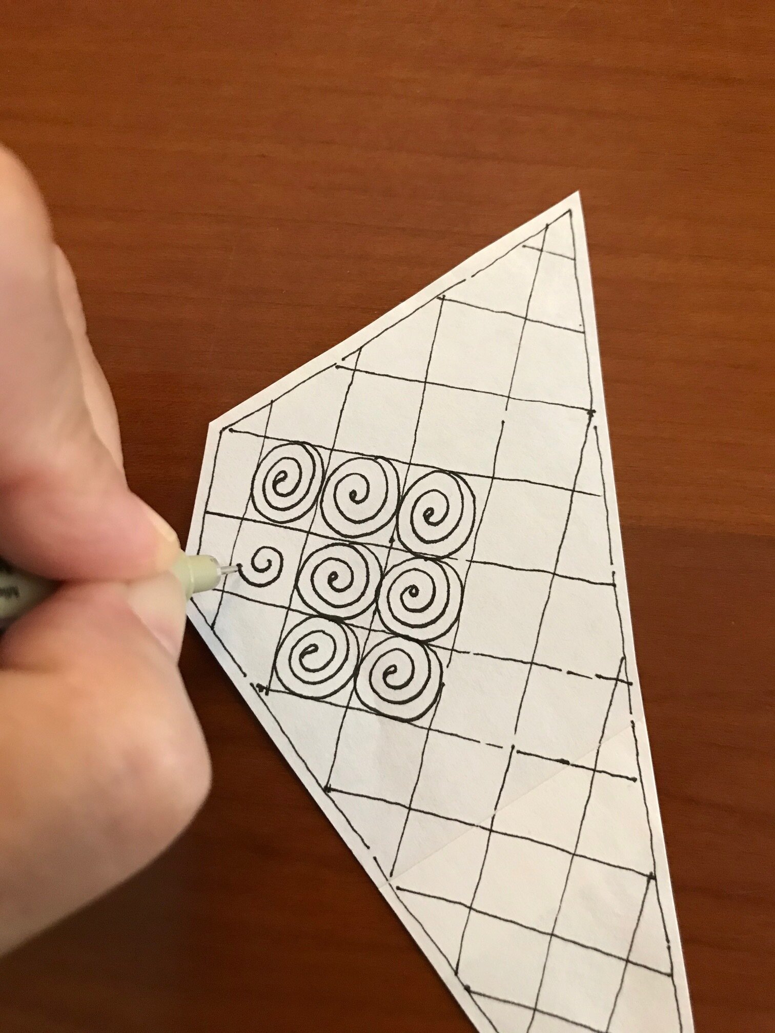  You may like to draw your spirals from the center out. 