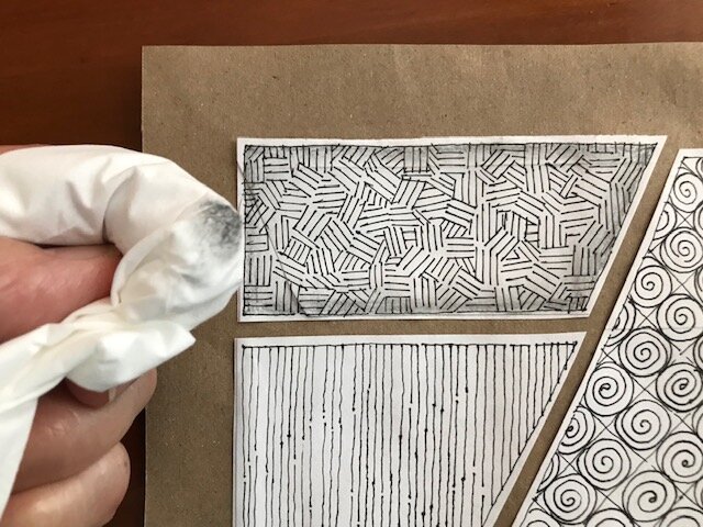  Using a tissue or paper towel, blend the graphite and soften the edges working your way into the center of the pattern.  