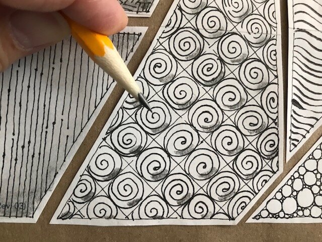  Imagining a light source coming from the upper left corner of your section would create a shadow in the bottom right of all the spirals. Add graphite in the bottom right corners.  