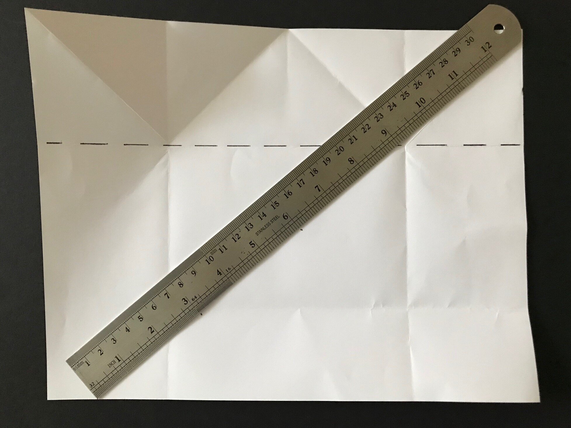  This part is really clever…You want to create a lengthwise fold one third from the bottom edge. You need to vertically divide the section below your previous horizontal fold (I’ve drawn a dash line) to the bottom edge into 3 equal sections. Lay your