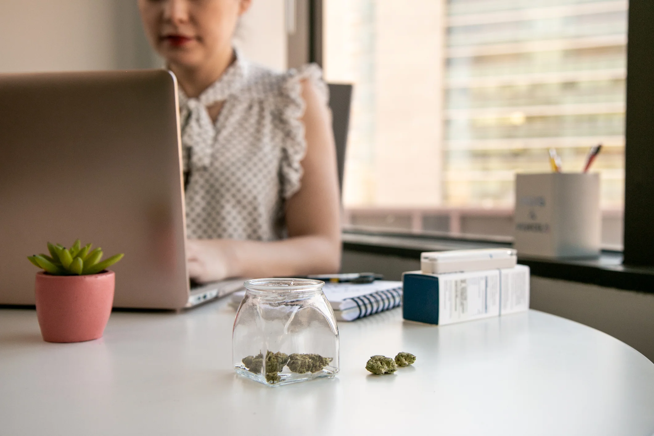Female-Cannabis-Entrepreneur-working-on-Marketing-for-Marijuana-Business-in-Bright,-Soft-Lit-Office-1129397827_2125x1417.jpeg