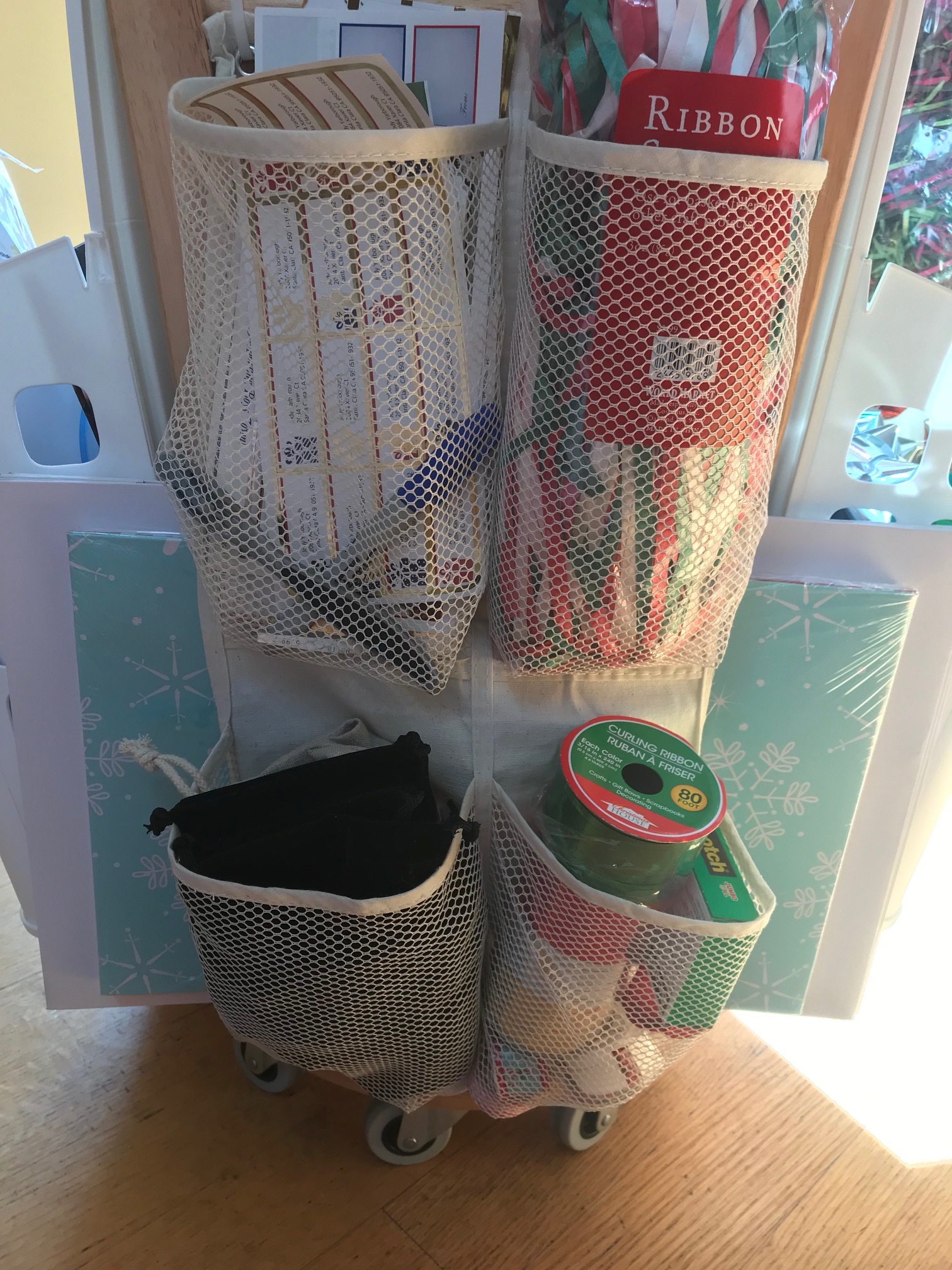 This side holds labels, extra supplies and other miscellaneous small items in mesh pockets of an over-the-door shoe organizer that I cut down to size.