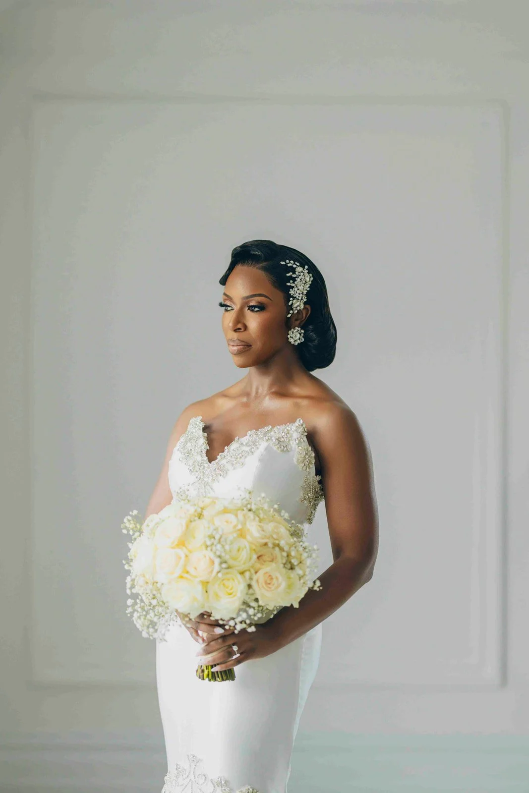 Bride in a white wedding gown posing indoors, photographed by Topflash Photography
