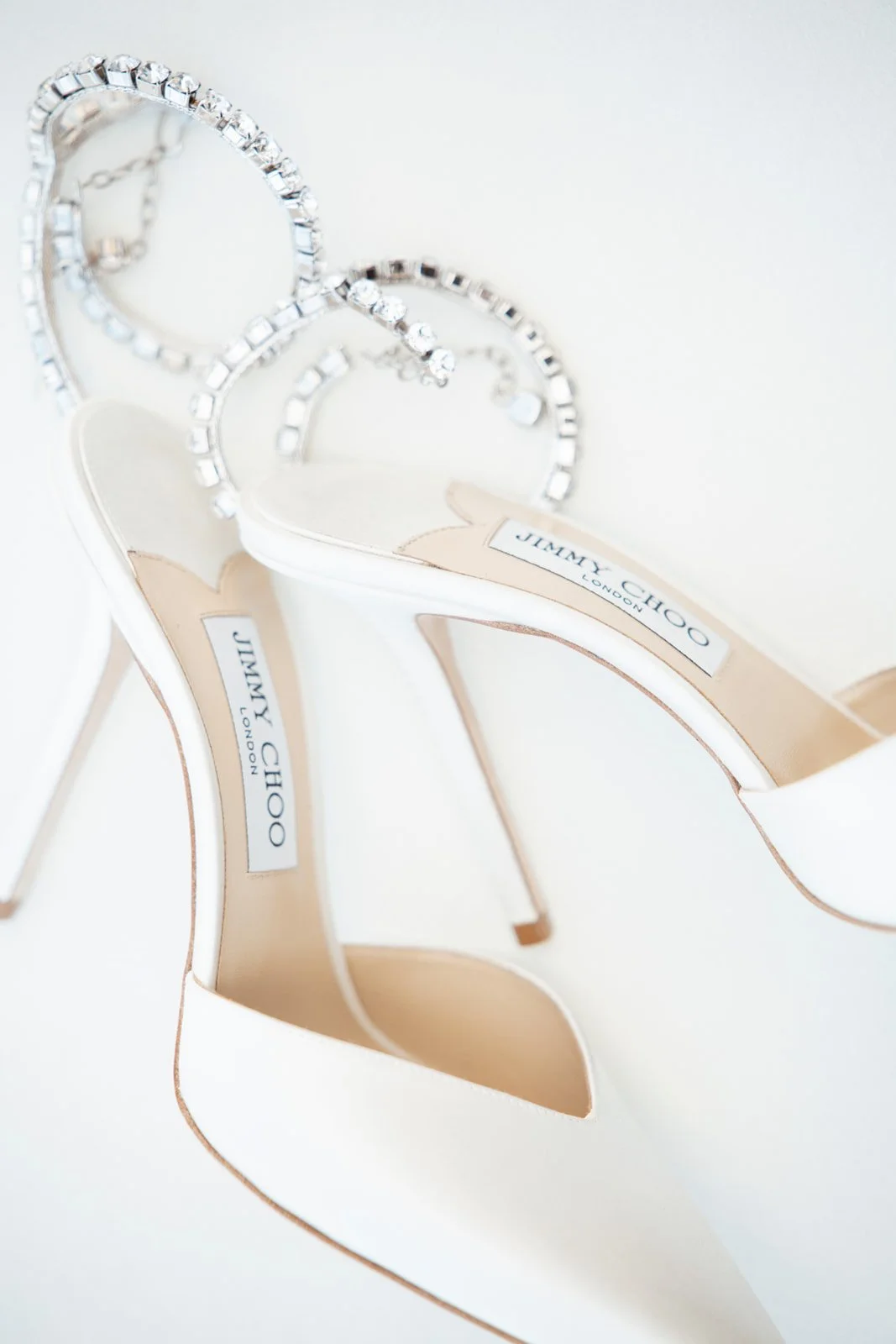 White wedding heels and jewelry arranged together, photographed by Topflash Photography