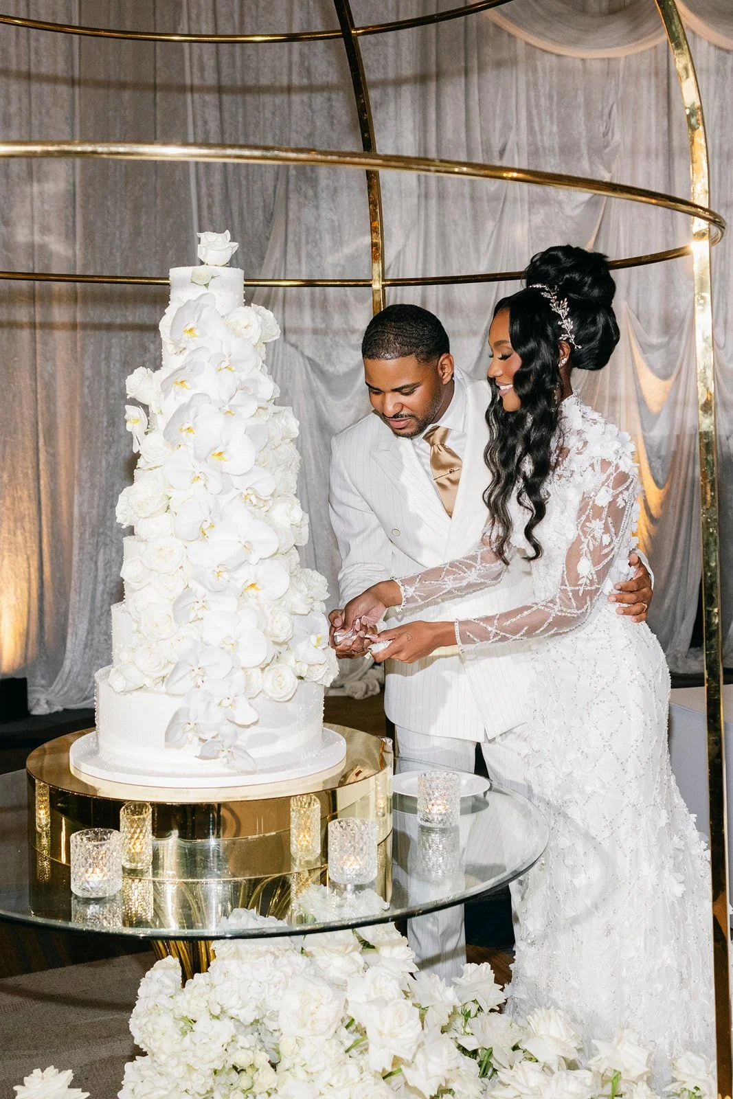Bride and groom posing indoors beside white drapery, photographed by Topflash Photography