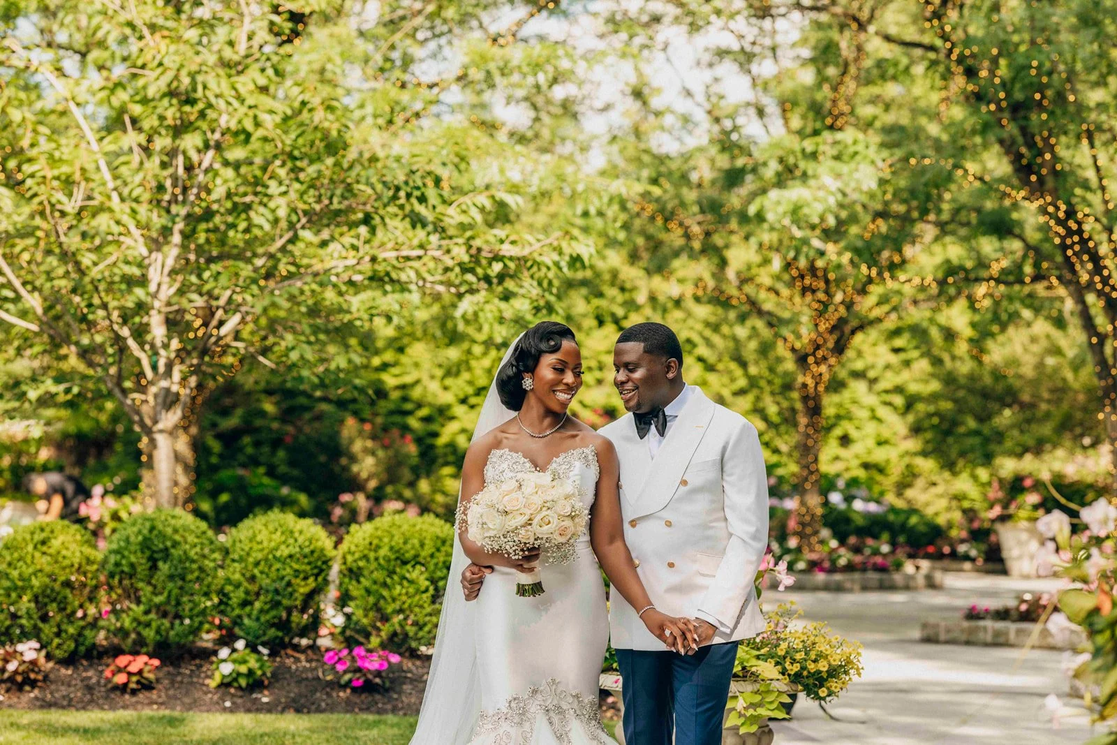 Bride and groom posing outdoors among leafy trees, photographed by Topflash Photography