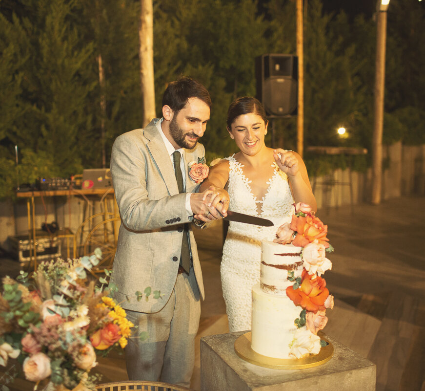  Charlotte and Andreas cutting the cake at their wedding at Aelia Wellness Resort in Tseri, Nicosia. Photographed by Cyprus wedding photographer Christine Constantine Photography. 