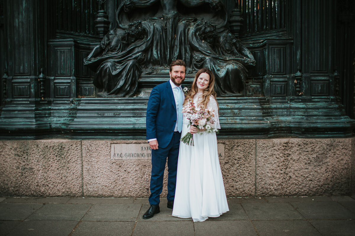  Jenny and James pose for their post-wedding photographs outside St James’ Palace in Pall Mall, London. 