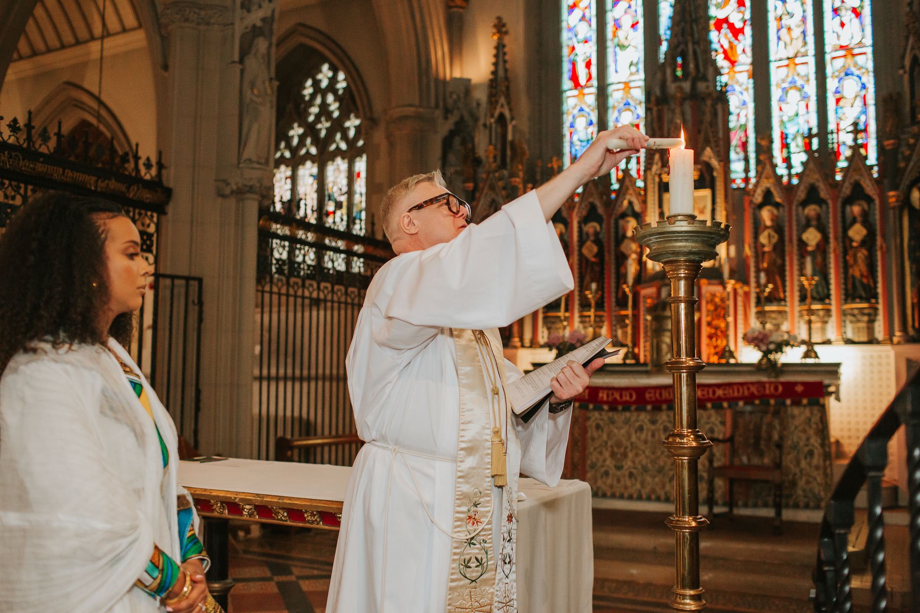 The priest performing a Christening at the St Mary's Roman Catholic Church in Clapham, London.
