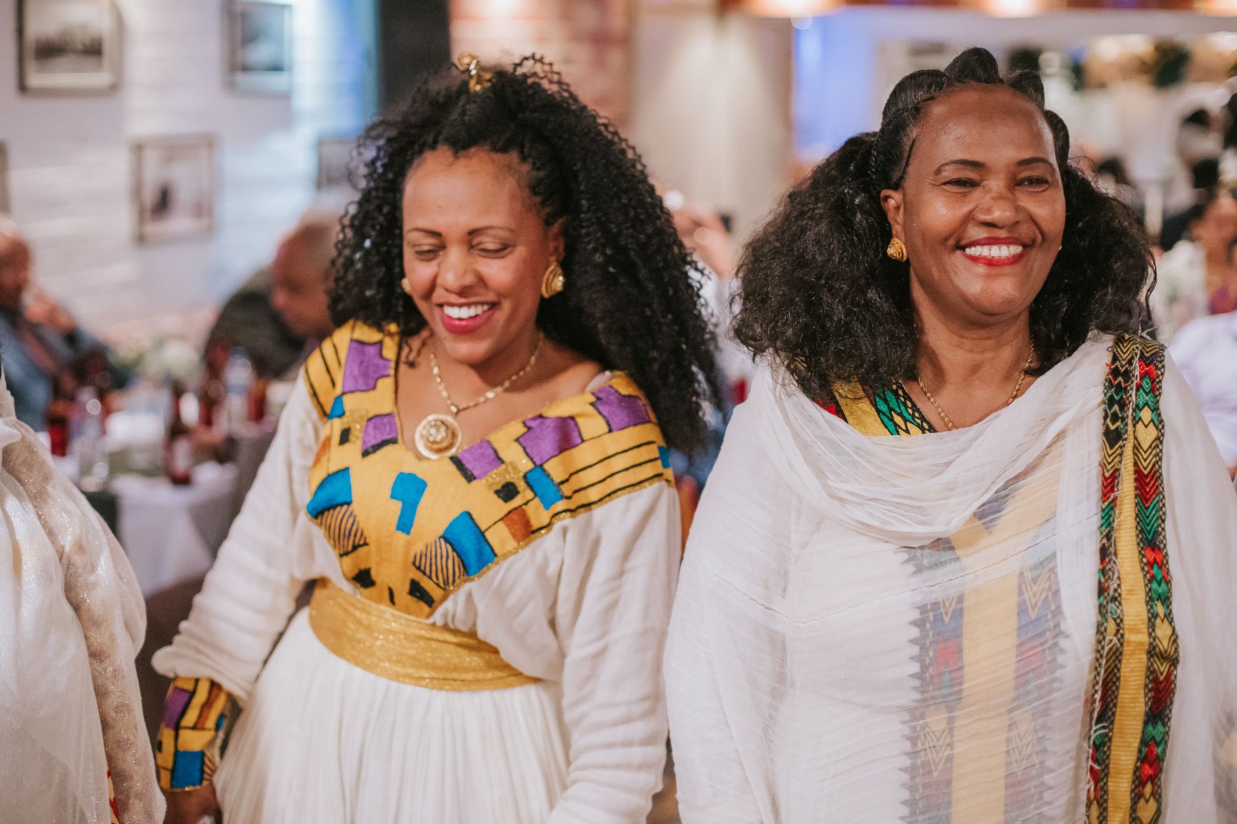 Guests of the Christening dancing and dressed in traditional Eritrean dress.