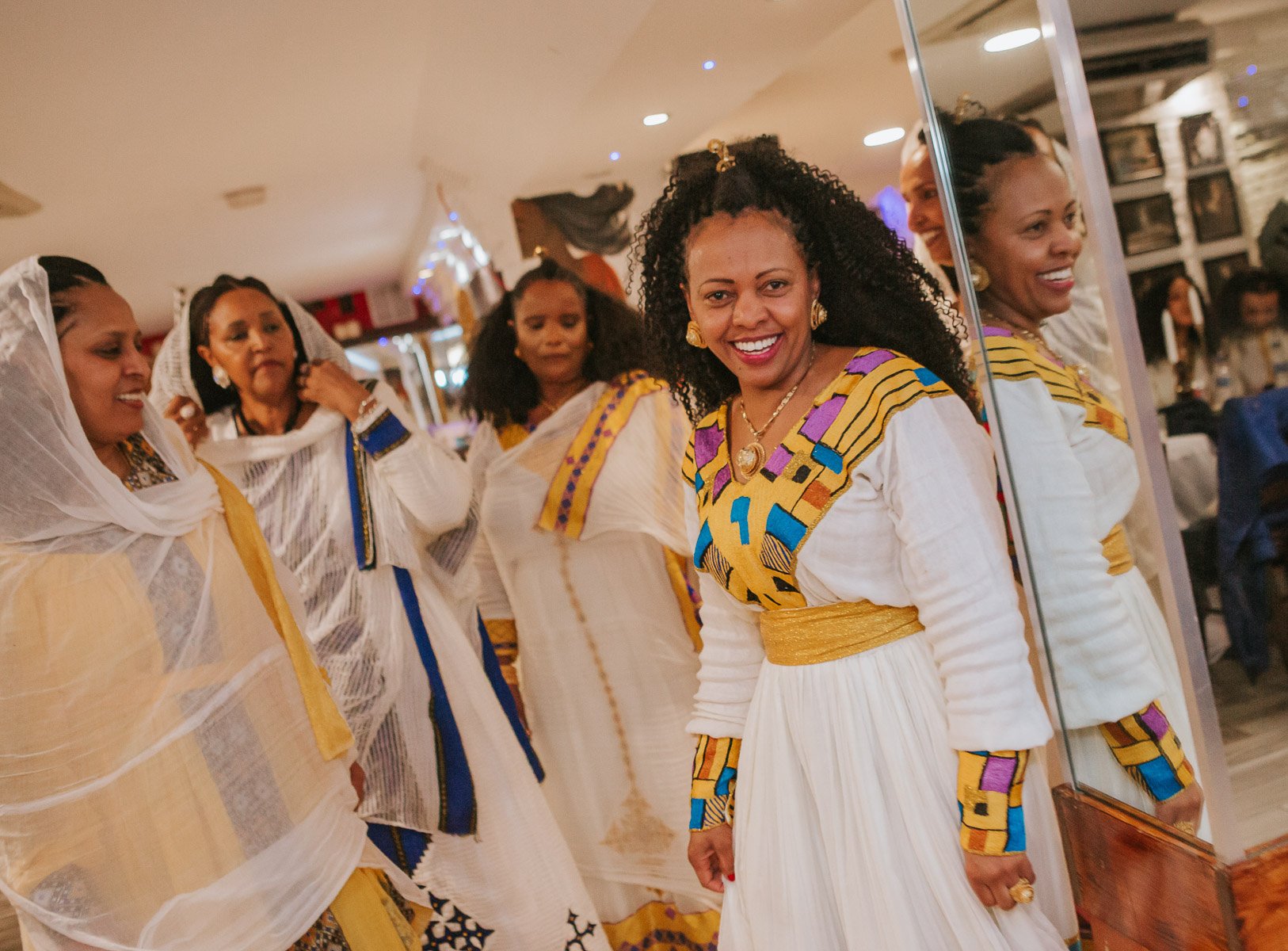 Guests of the Christening dancing and dressed in traditional Eritrean dress.