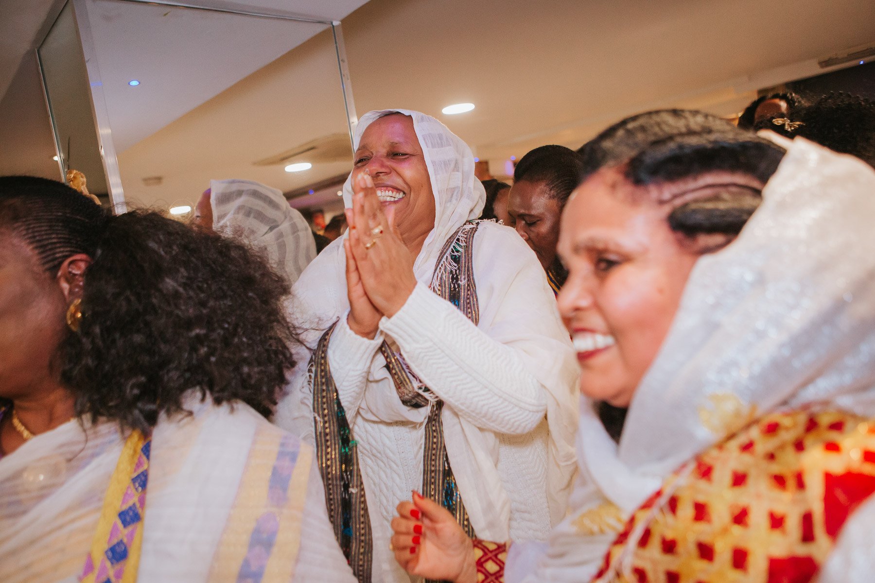 Guests of the Christening dancing and dressed in traditional Eritrean dress.