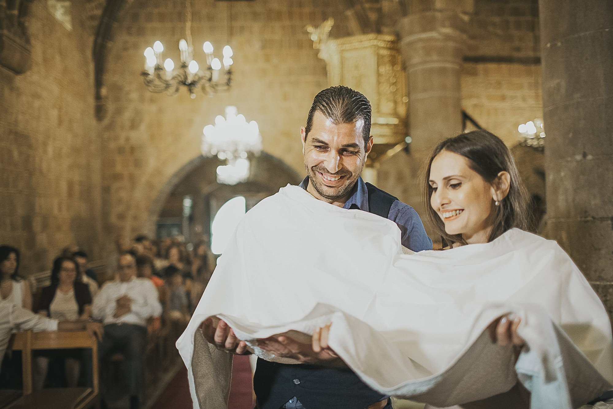 godparents receiving the christened baby