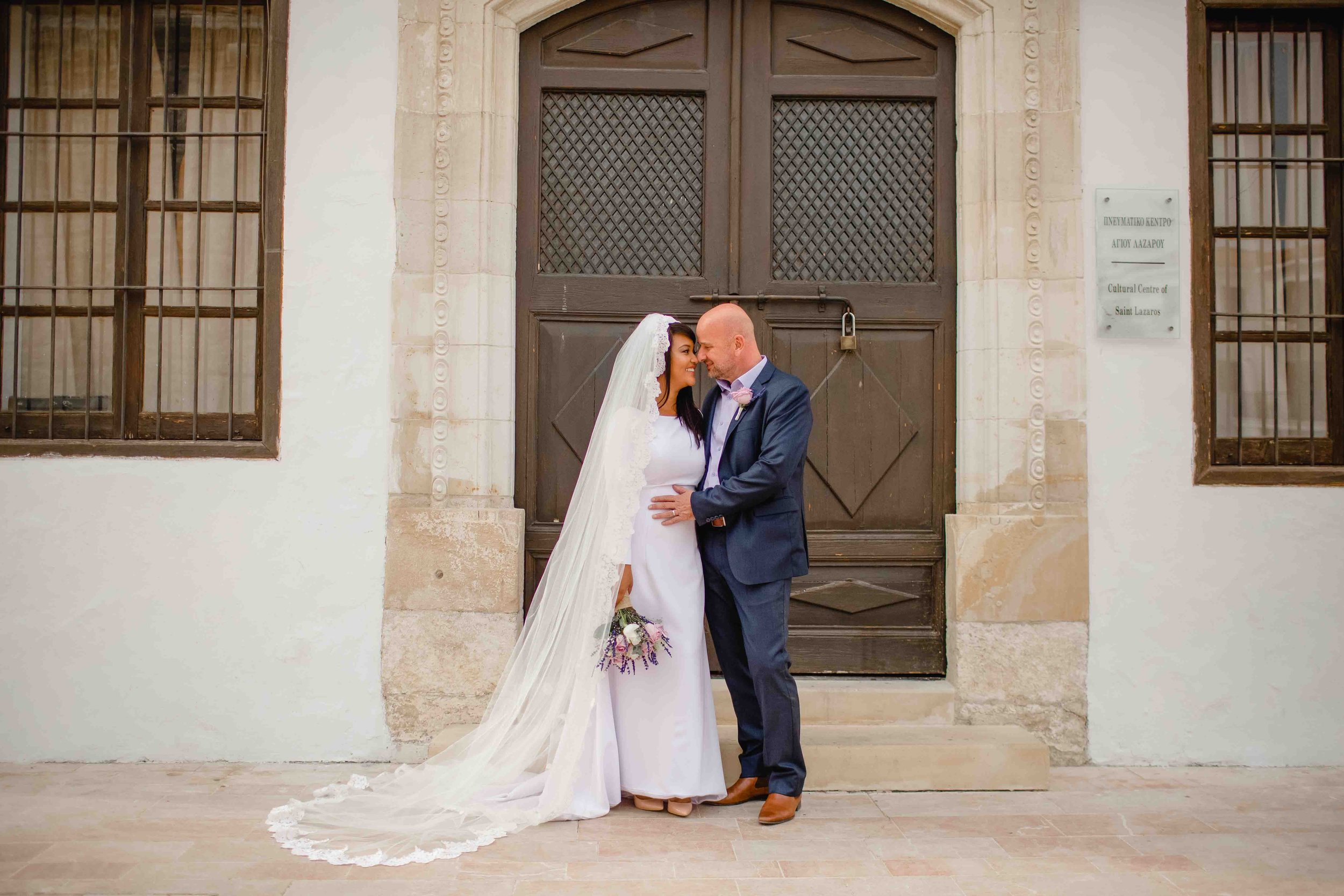 Bride Tammi and groom Demi posing outside St Lazarus Church, Larnaca