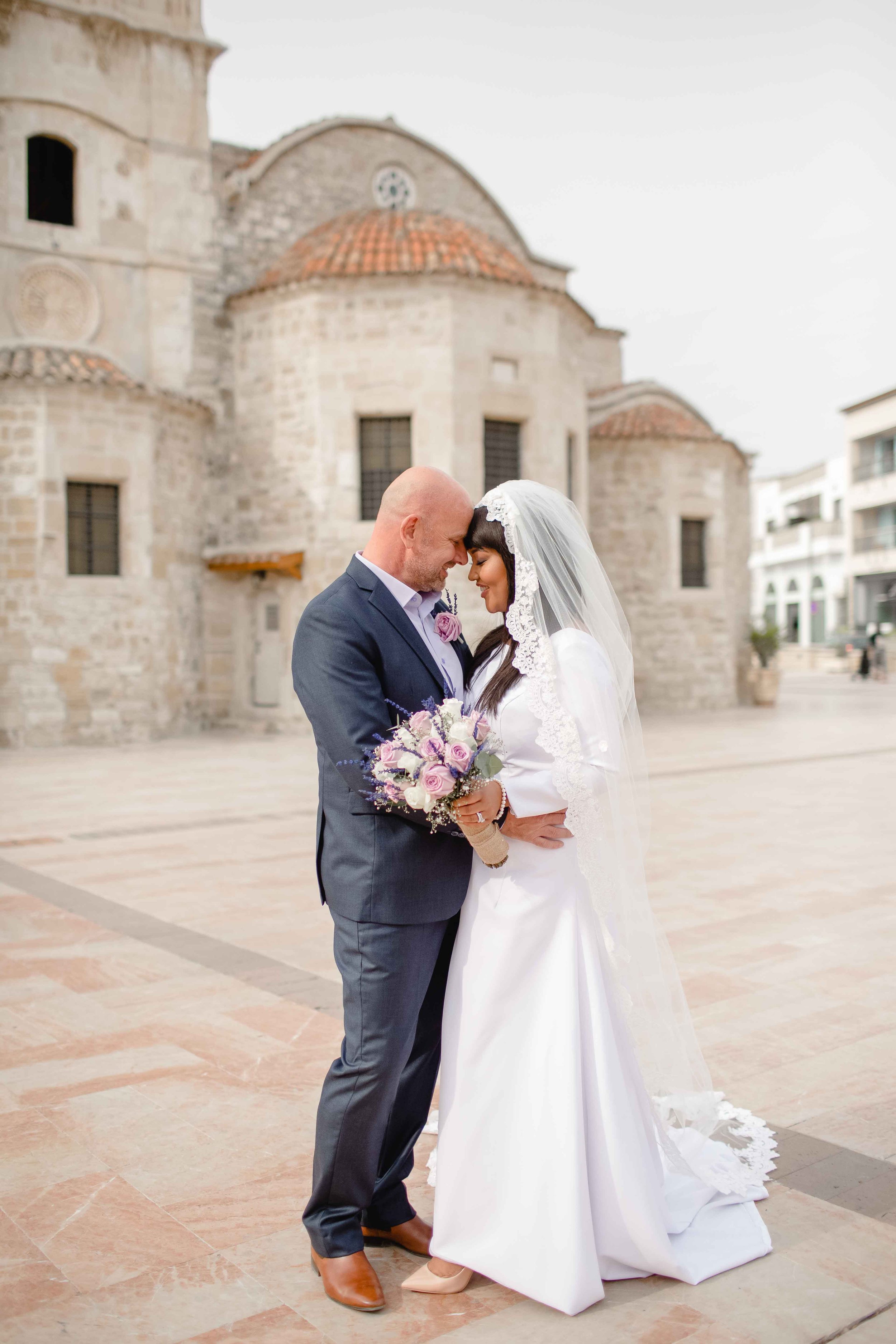 Bride Tammi and groom Demi posing outside St Lazarus Church, Larnaca