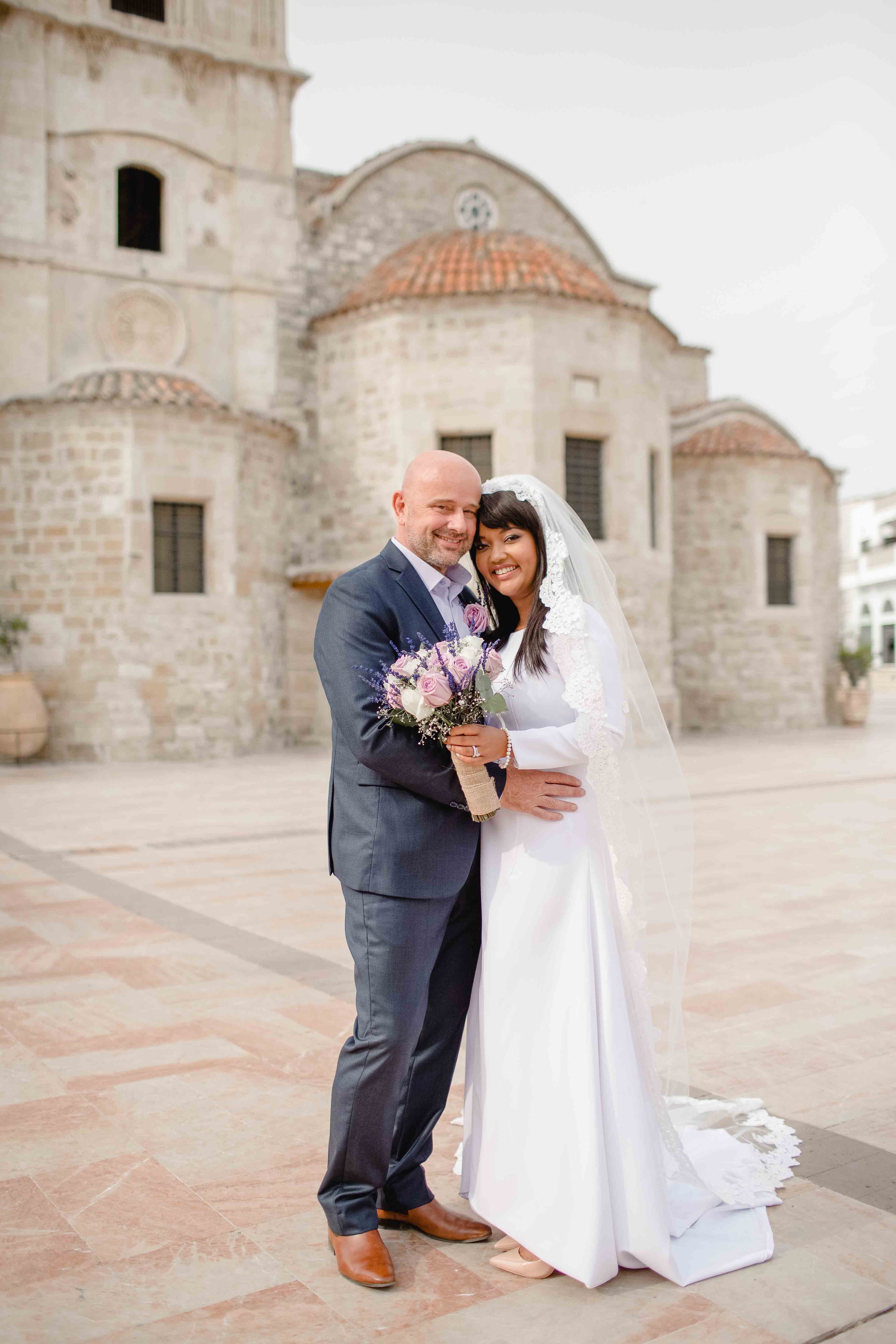 Bride Tammi and groom Demi posing outside St Lazarus Church, Larnaca