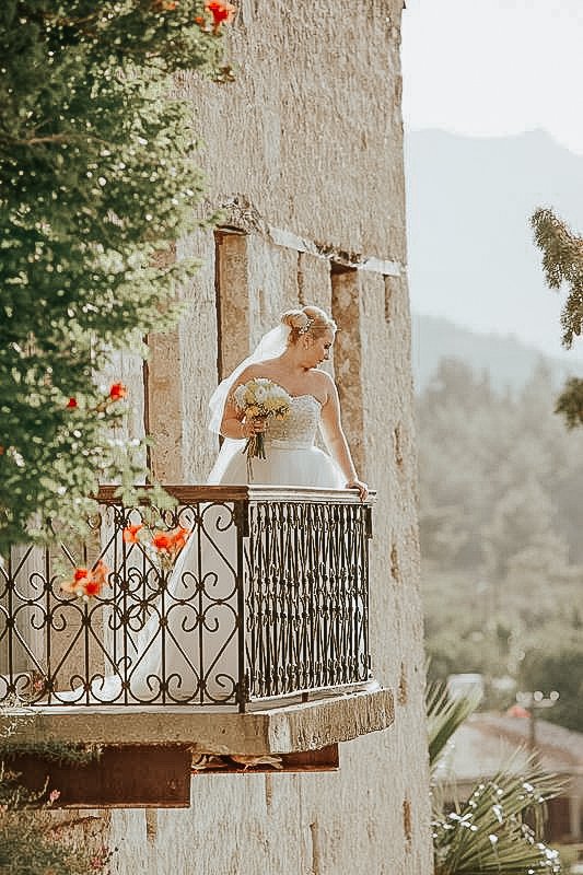 Bride posing after her wedding on the balcony at Bellapais Abbey.