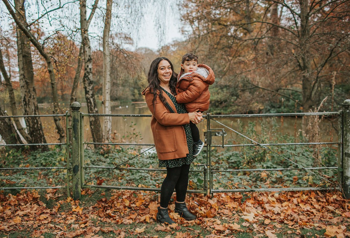 Mum and son in front of Hampstead Heath pond.