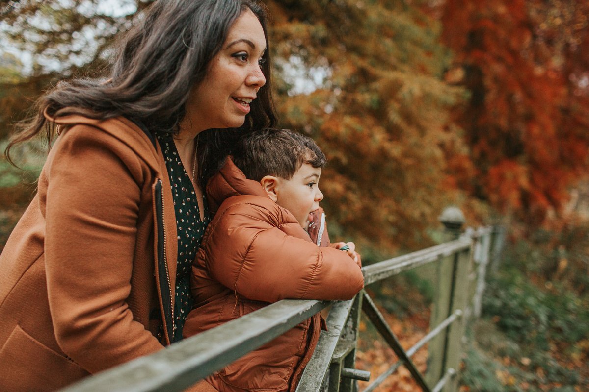 Mum and son overlooking Hampstead Heath pond.