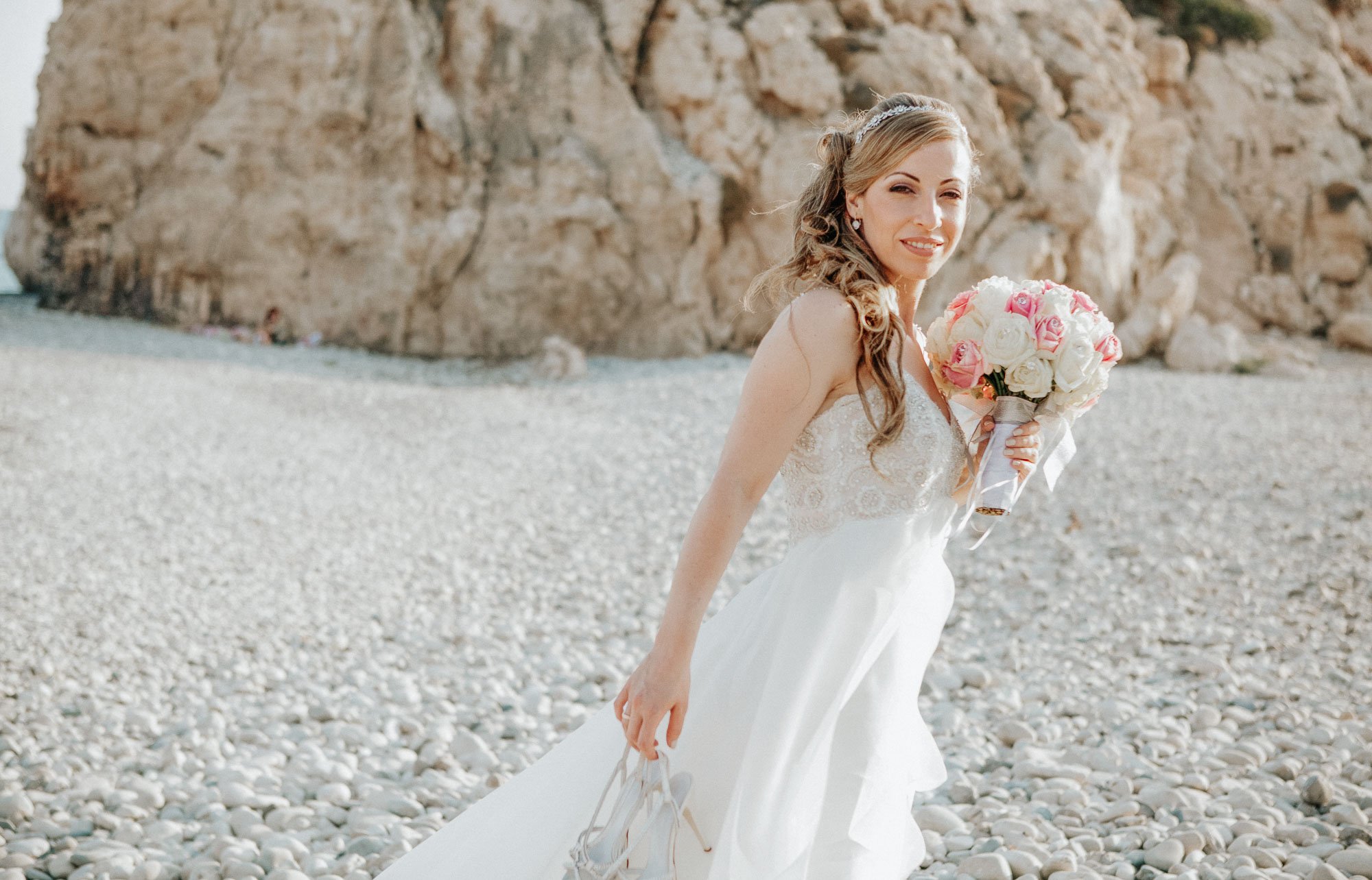 Bride posing in front of Aphrodites Rock, Cyprus