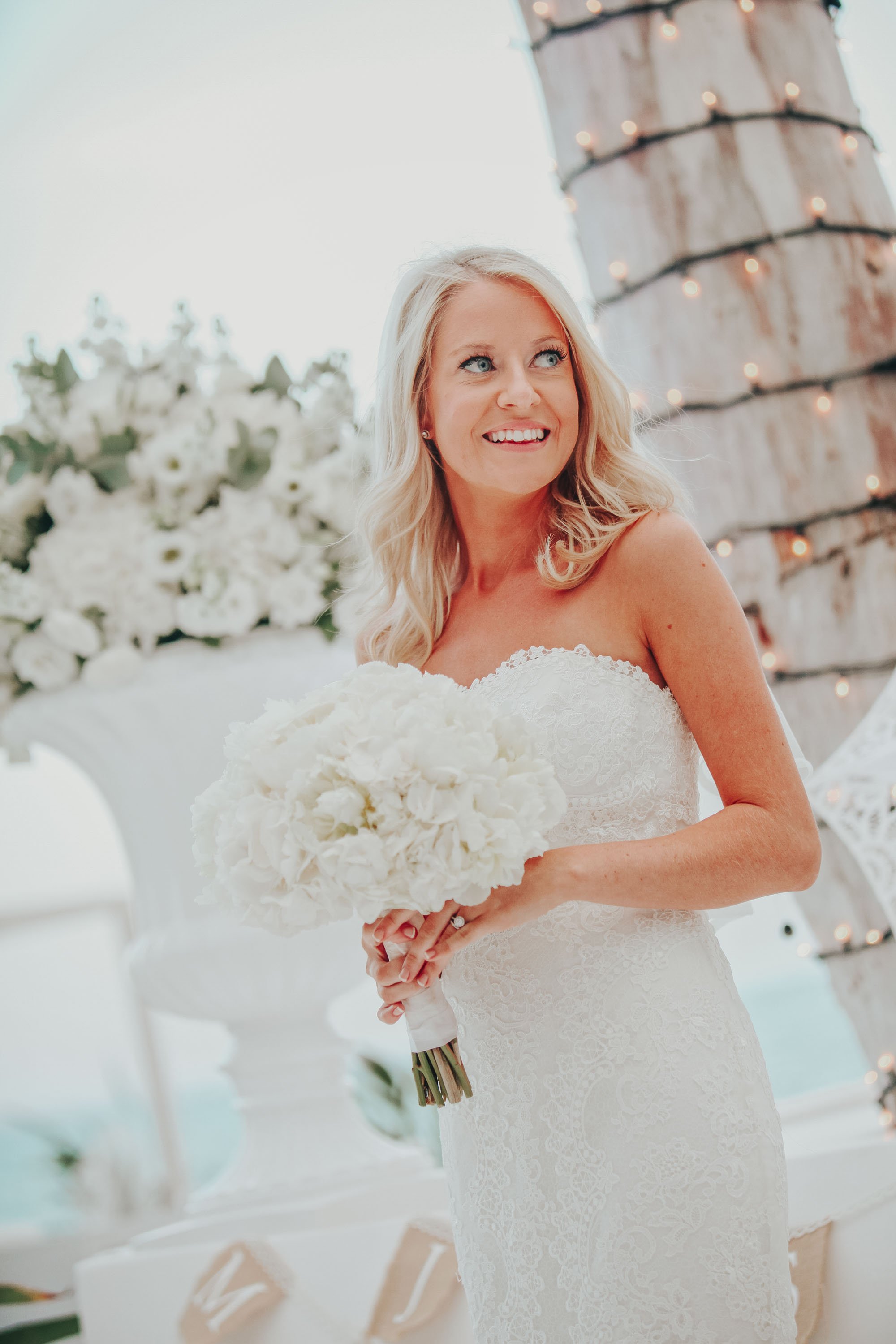 Bride standing front palm tree at galu seaside.