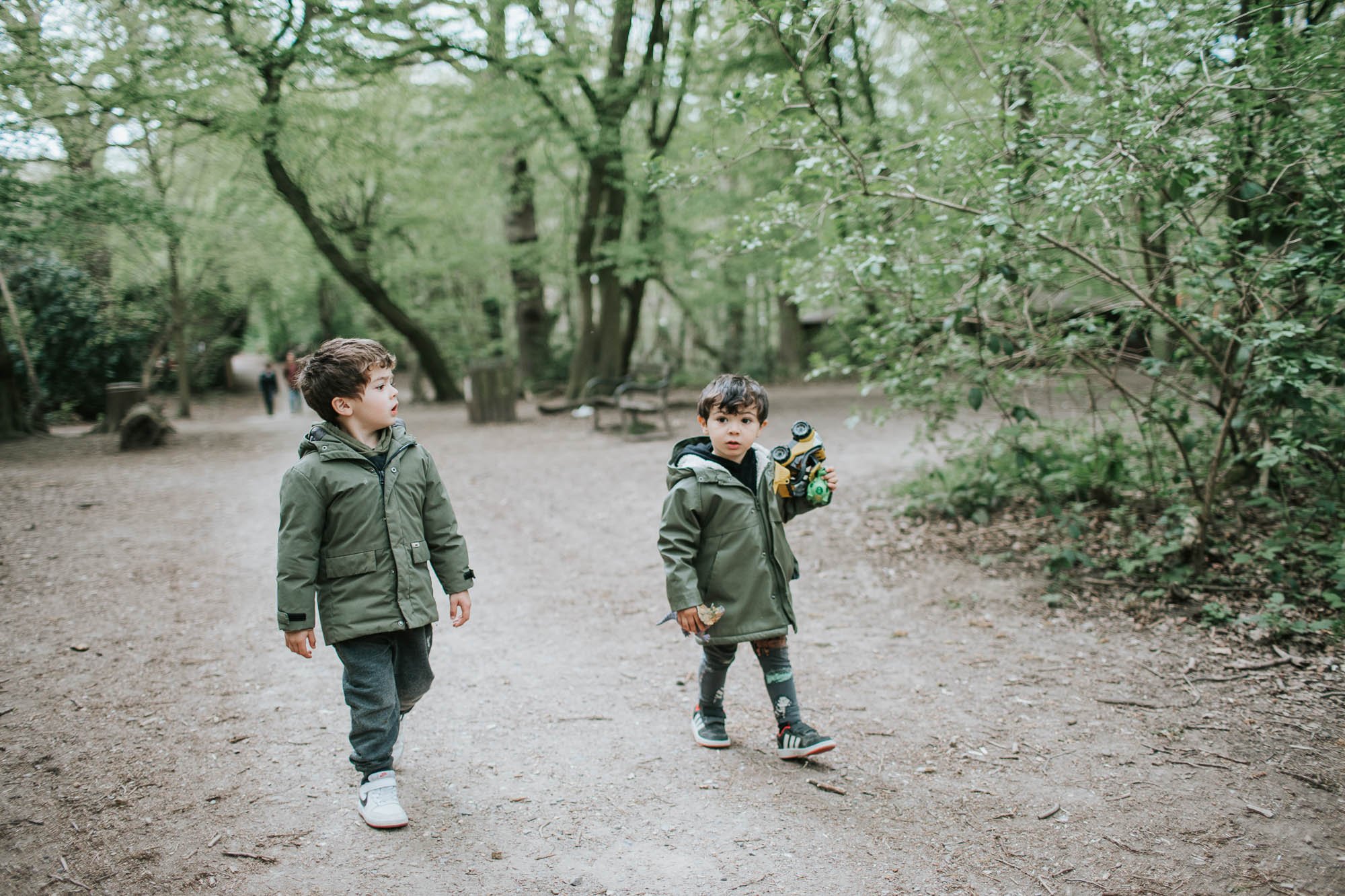 Two boys walking along in Highgate Woods.