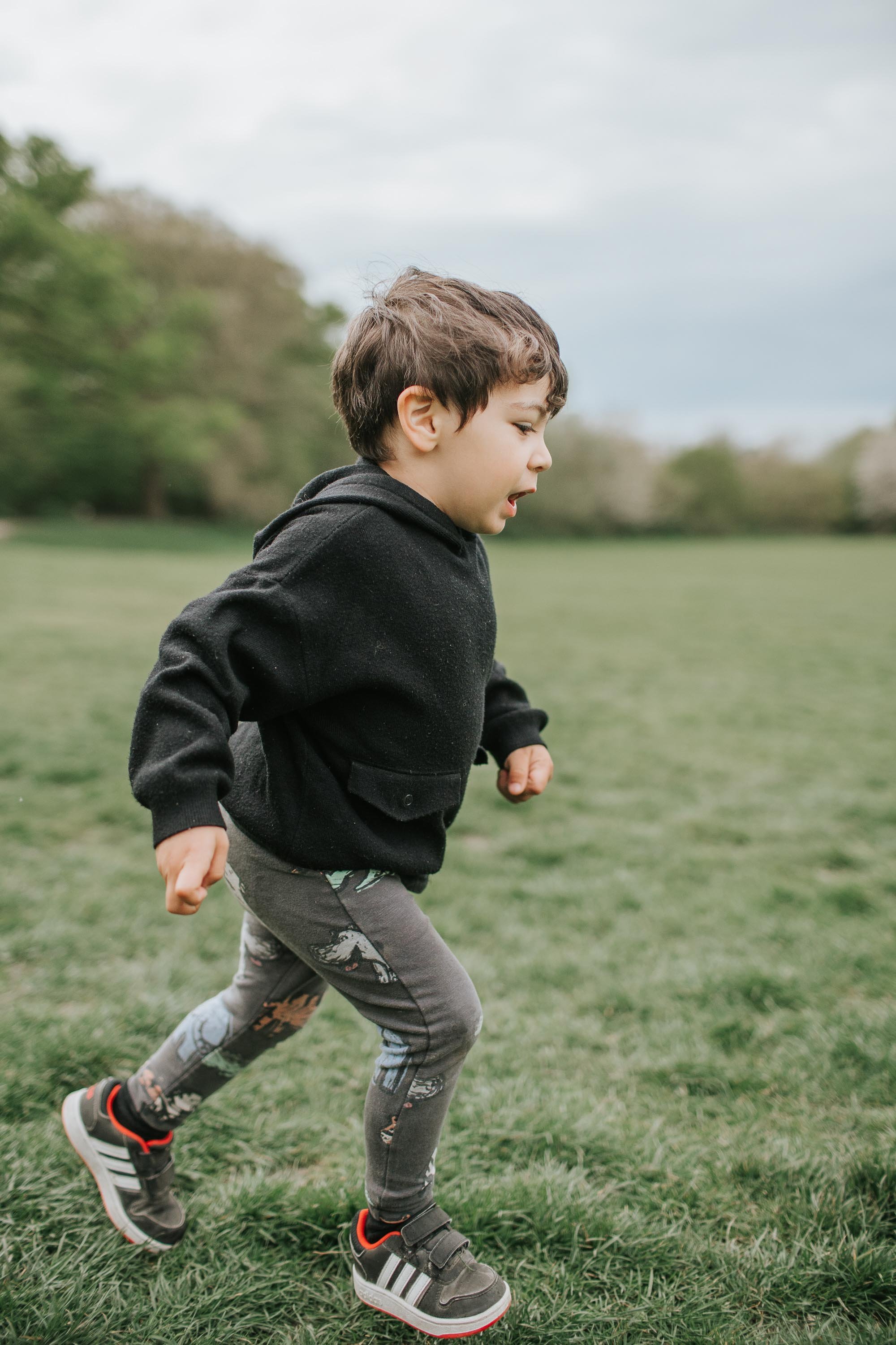 Young boy running in Highgate Woods.