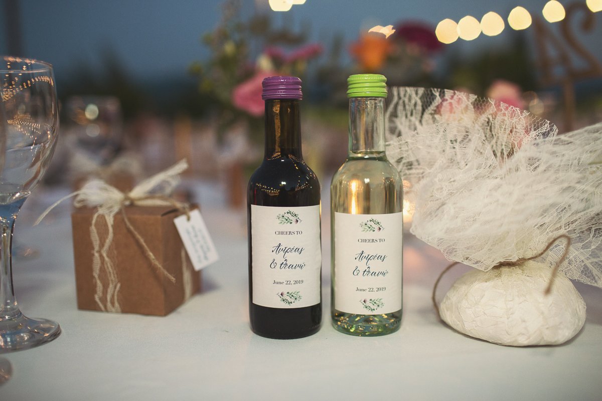 Wedding table with bottles of aes ambelis wine at Aes Ambelis winery.