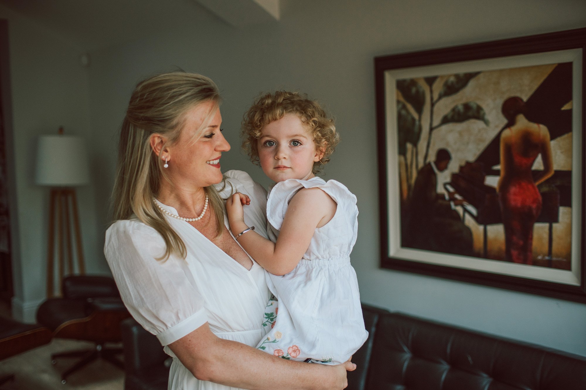 Joy-Anne holding her daughter in their house in Tooting, South London.