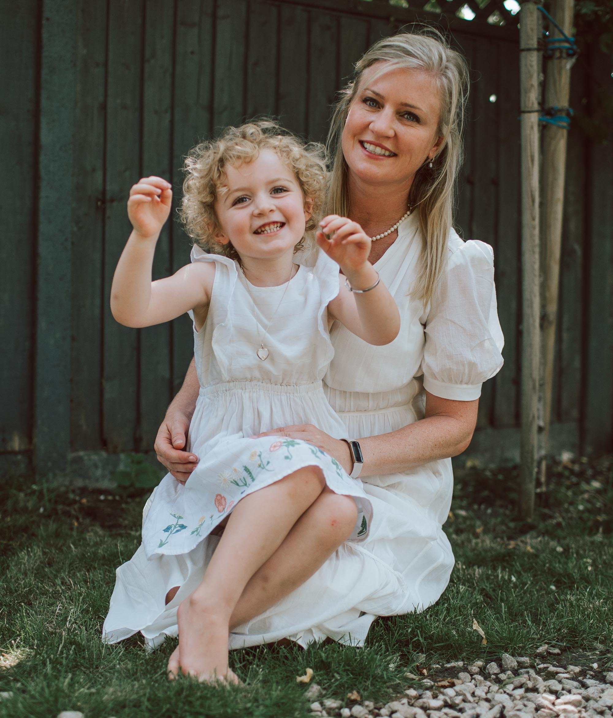 Jot-Anne and her daughter sitting in their garden.