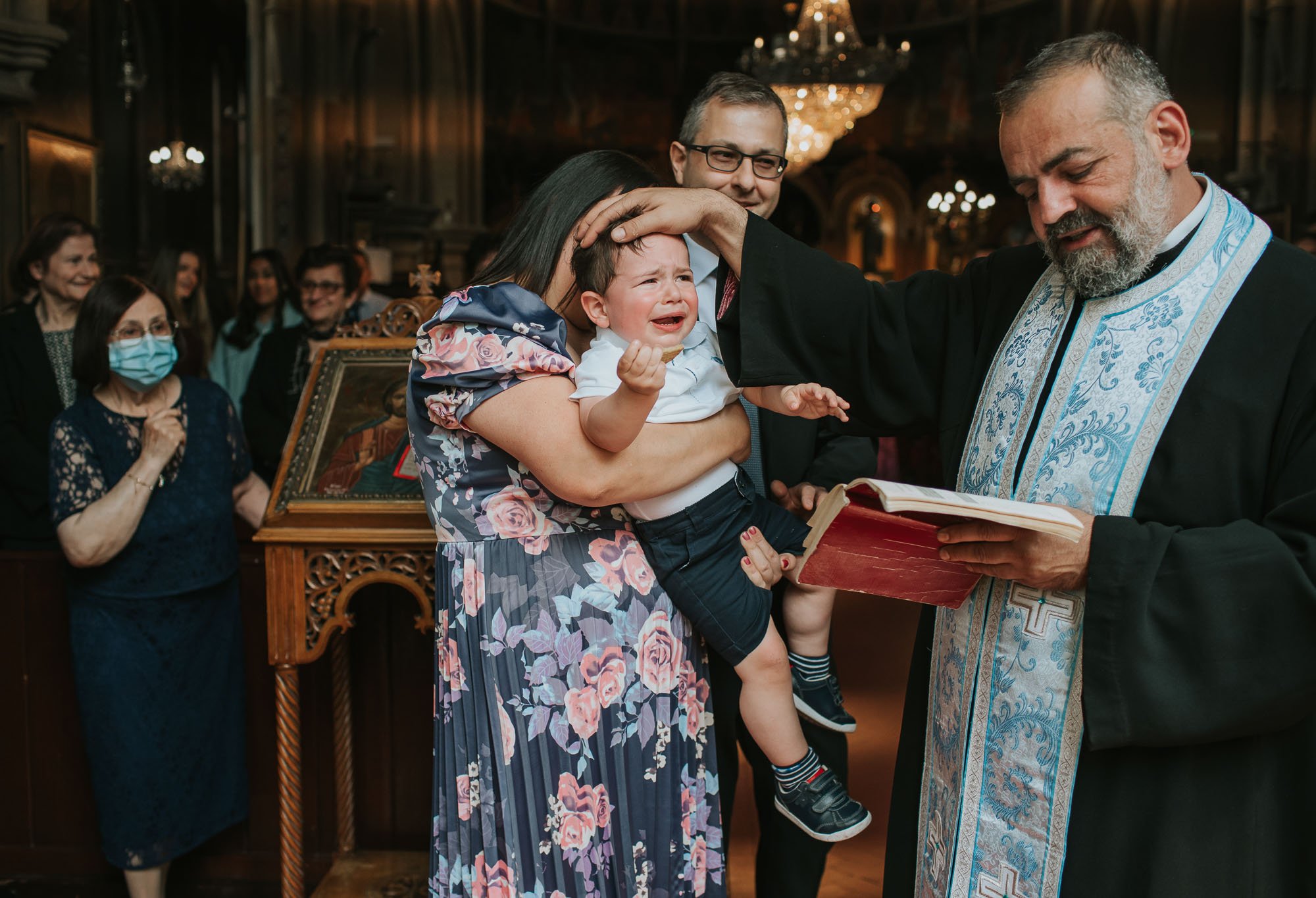  Tommy being blessed by the priest during his Greek Christening. 