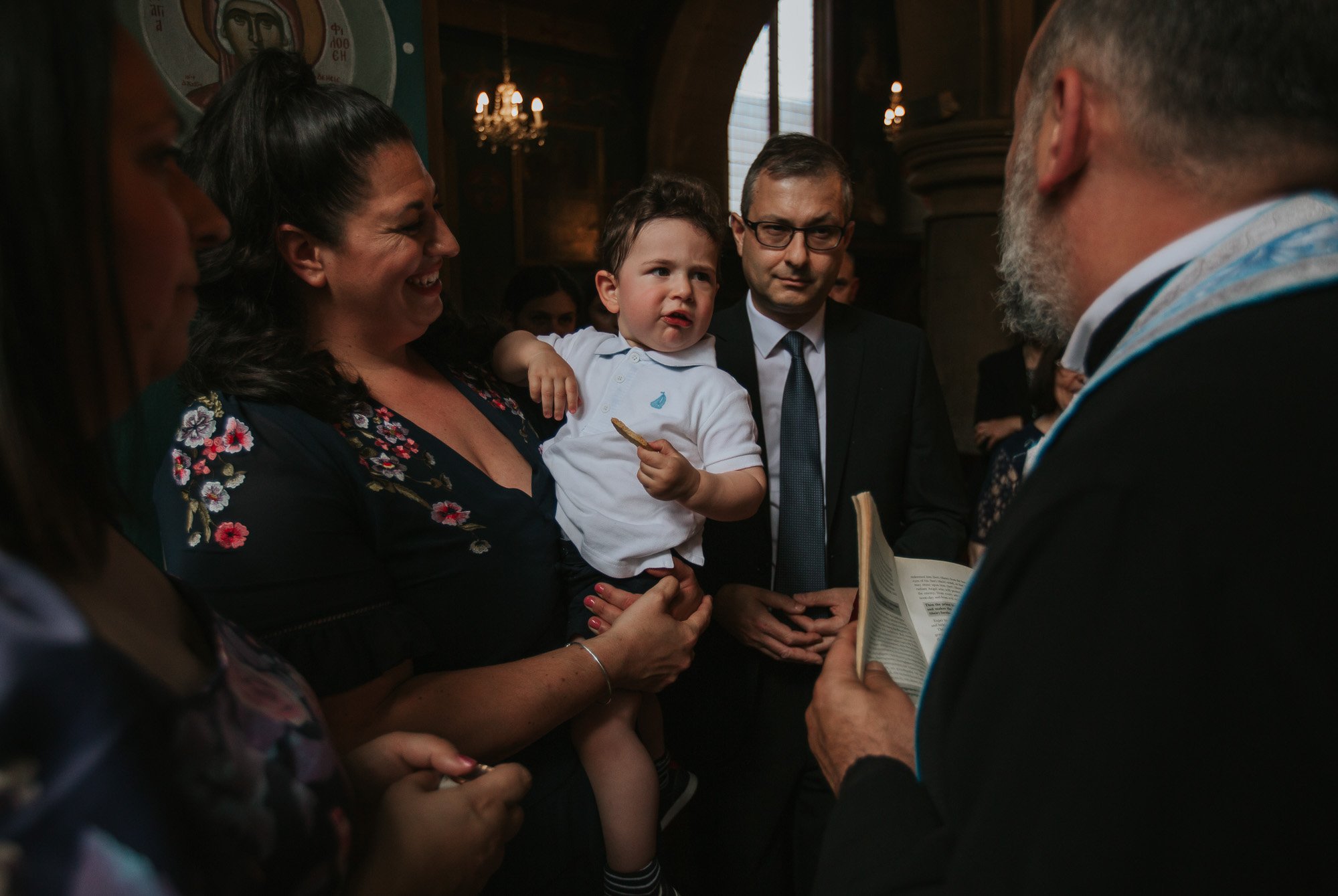  Tommy being blessed by the priest during his Greek Christening. 