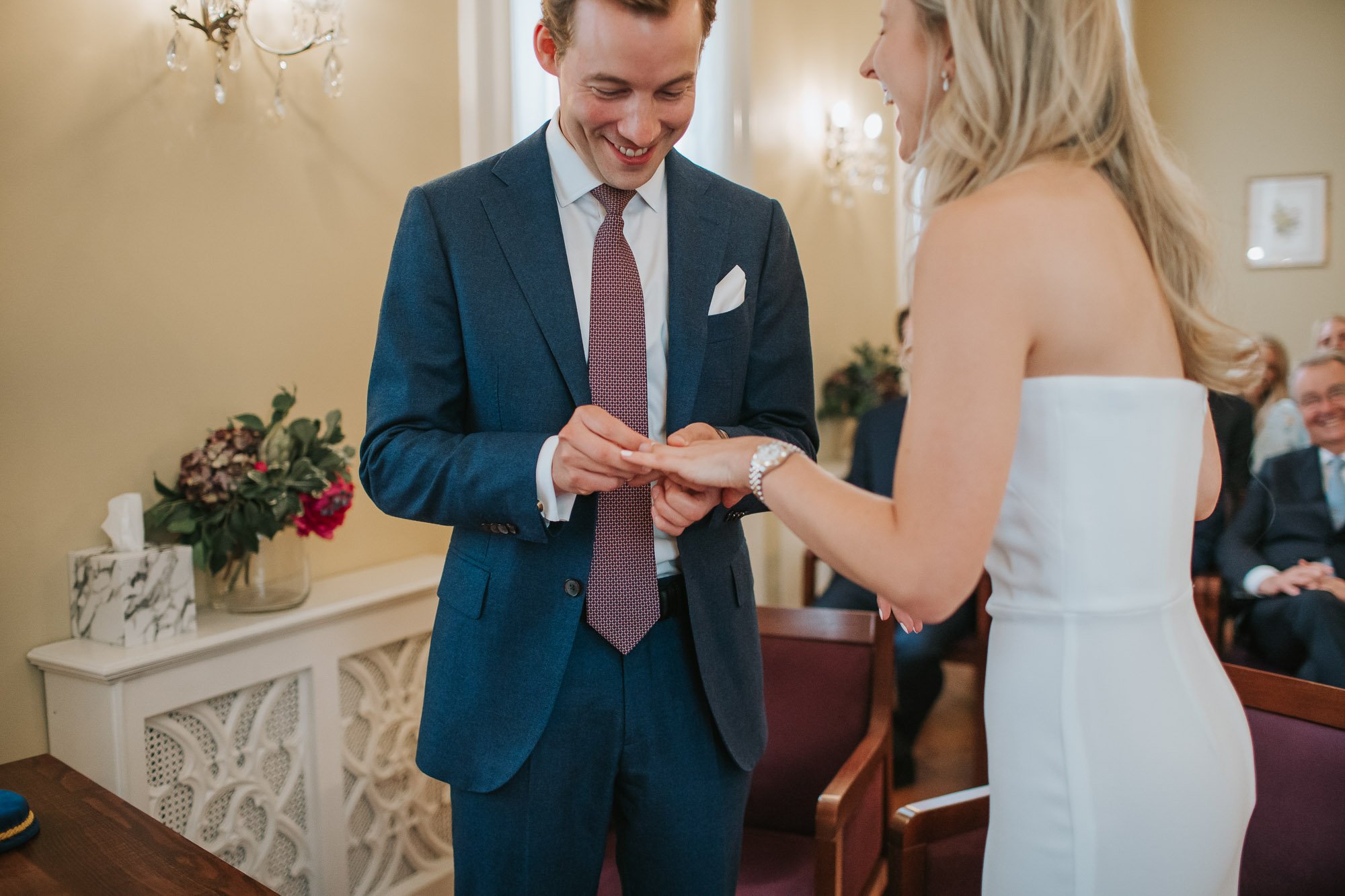 Bride and groom exchanging rings at chelsea old town hall.