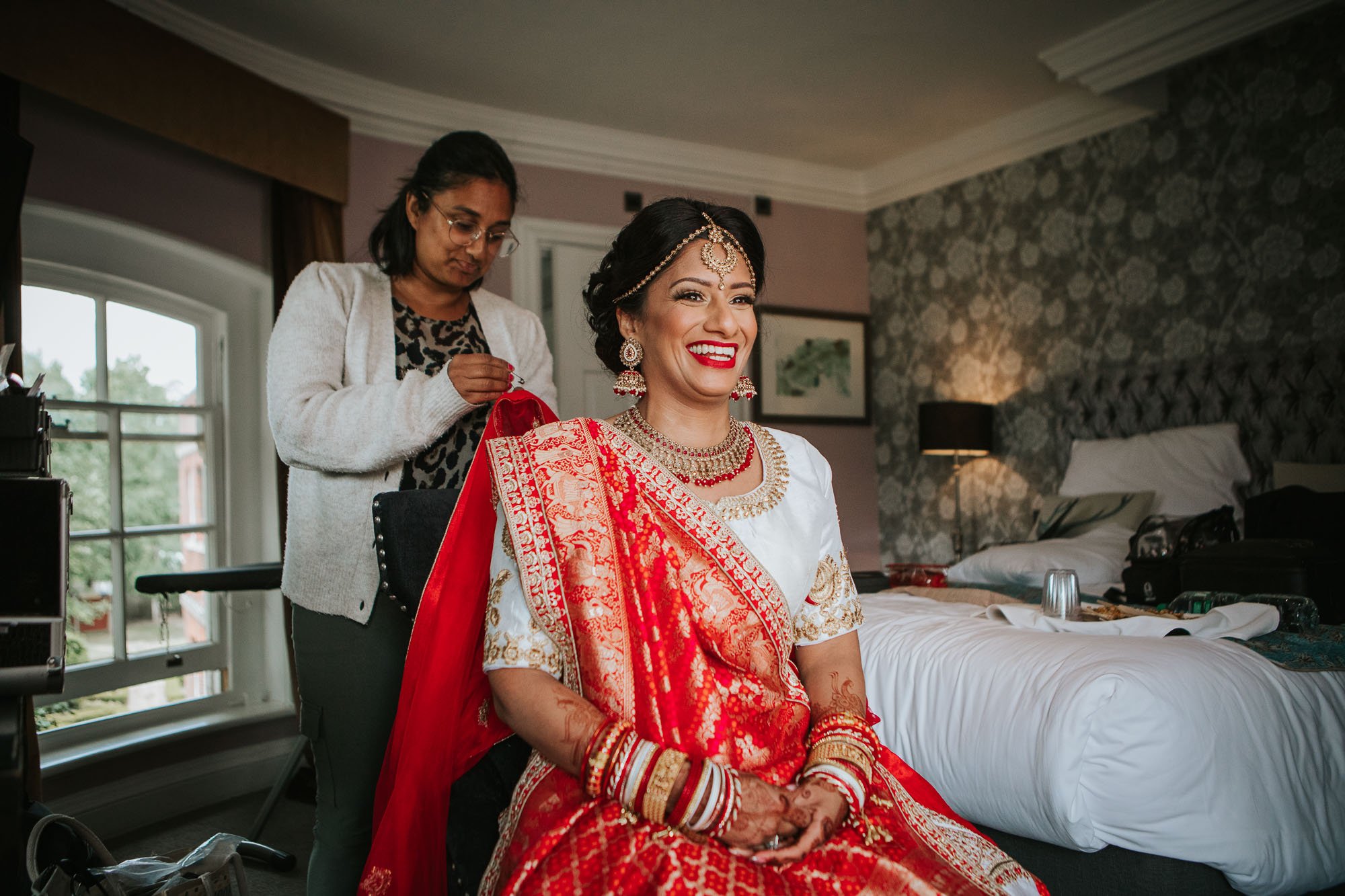Smiling Hindu Bride dressed in traditional red sari.